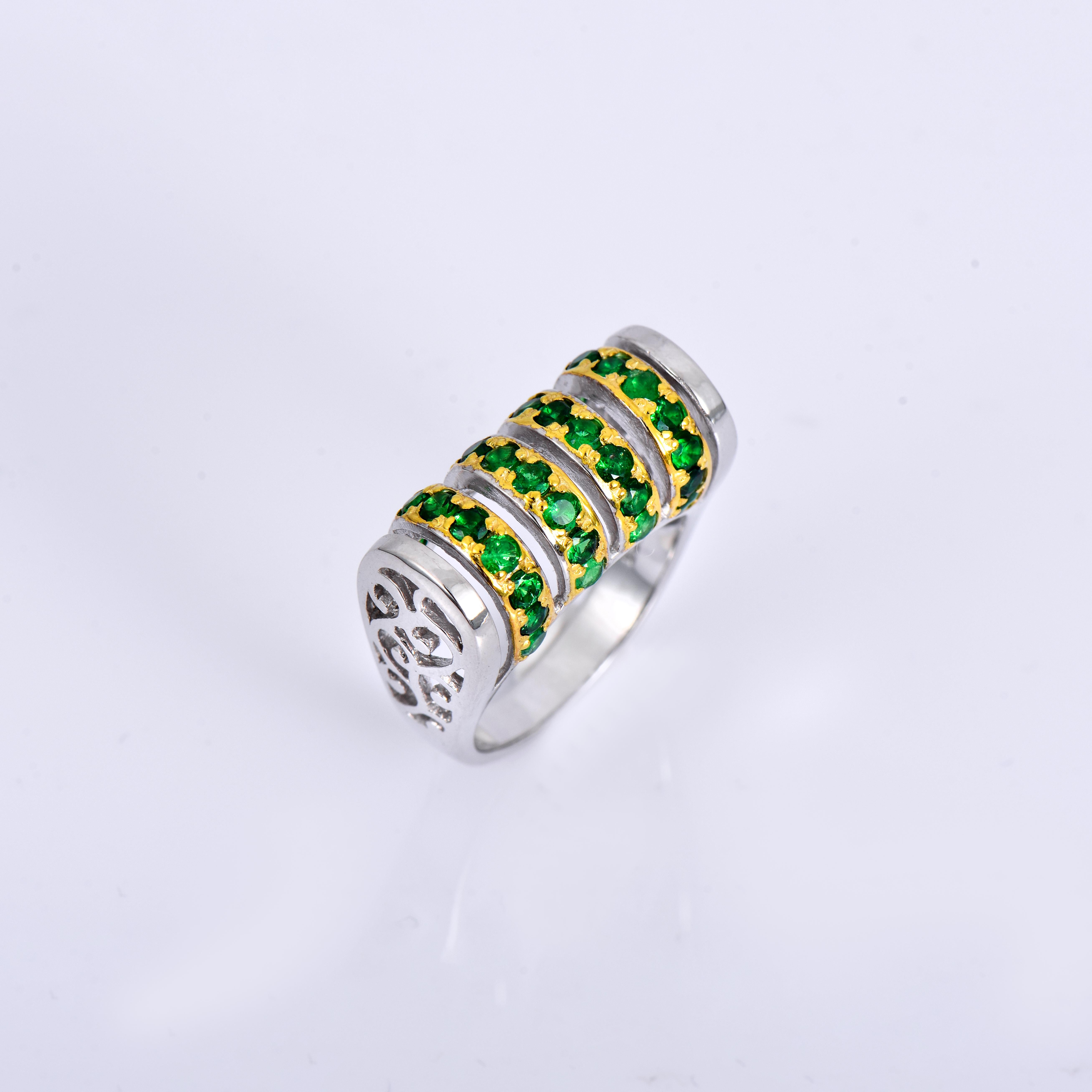 Orloff of Denmark; Tsavorite Garnet ring fashioned out of 925 Sterling Silver, plated with 18 Karat Gold.

This sterling silver ring is adorned with thirty-two delicate green tsavorites, each measuring 2.6 mm in diameter. The tsavorites are