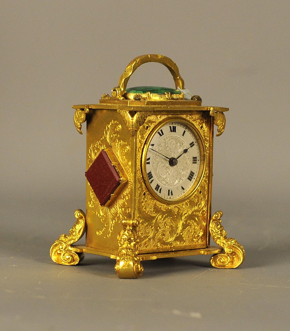 This is an extremely rare and beautiful ormolu-mounted miniature timepiece carriage clock with thermometer and agate lozenges panels to the side and a malachite cabochon to the top which is in wonderful original condition.
The case is beautifully