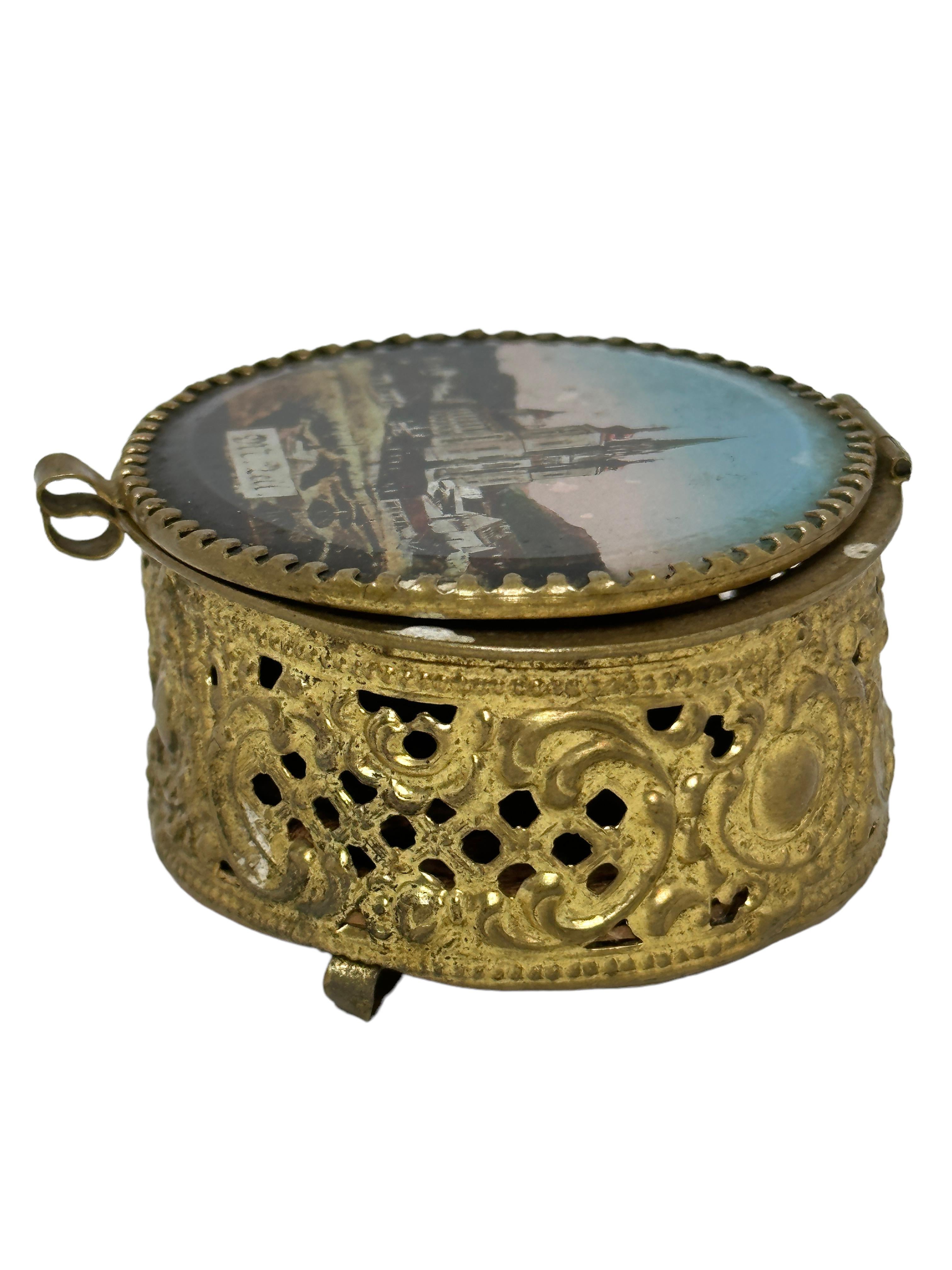 A gorgeous glass top trinket box made of ormolu. The hinged top featuring a view of the church of Maria Zell place of pilgrimage in Austria. No restoration has been carried out on this charming little trinket box, which remains in very stabile and