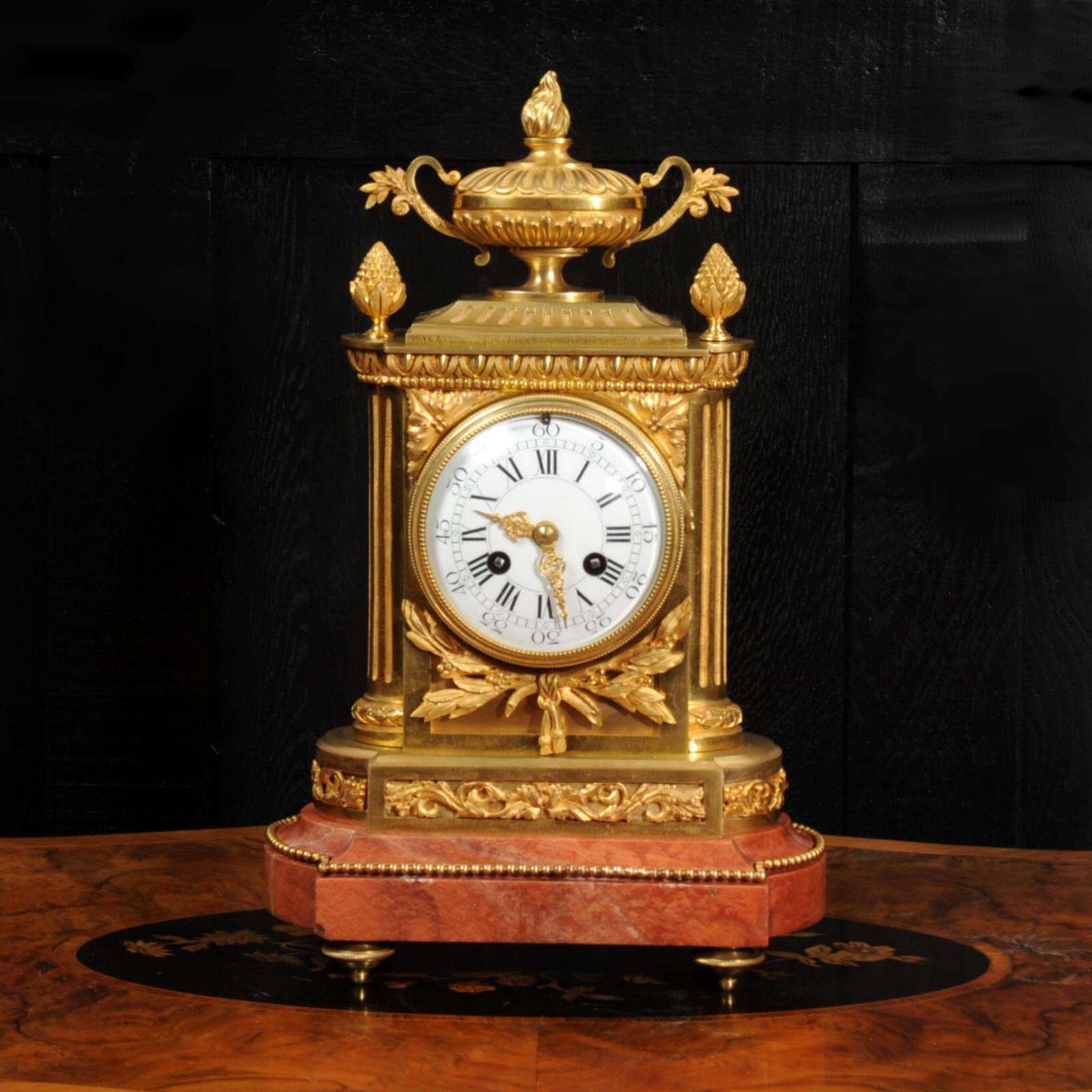 A stunning original antique French clock by the famous bronze founder Charpentier of Paris. It is Louis XVI neoclassical style and of superb quality, made in ormolu (finely gilded bronze). The case is formed with fluted pilasters with semi-circular