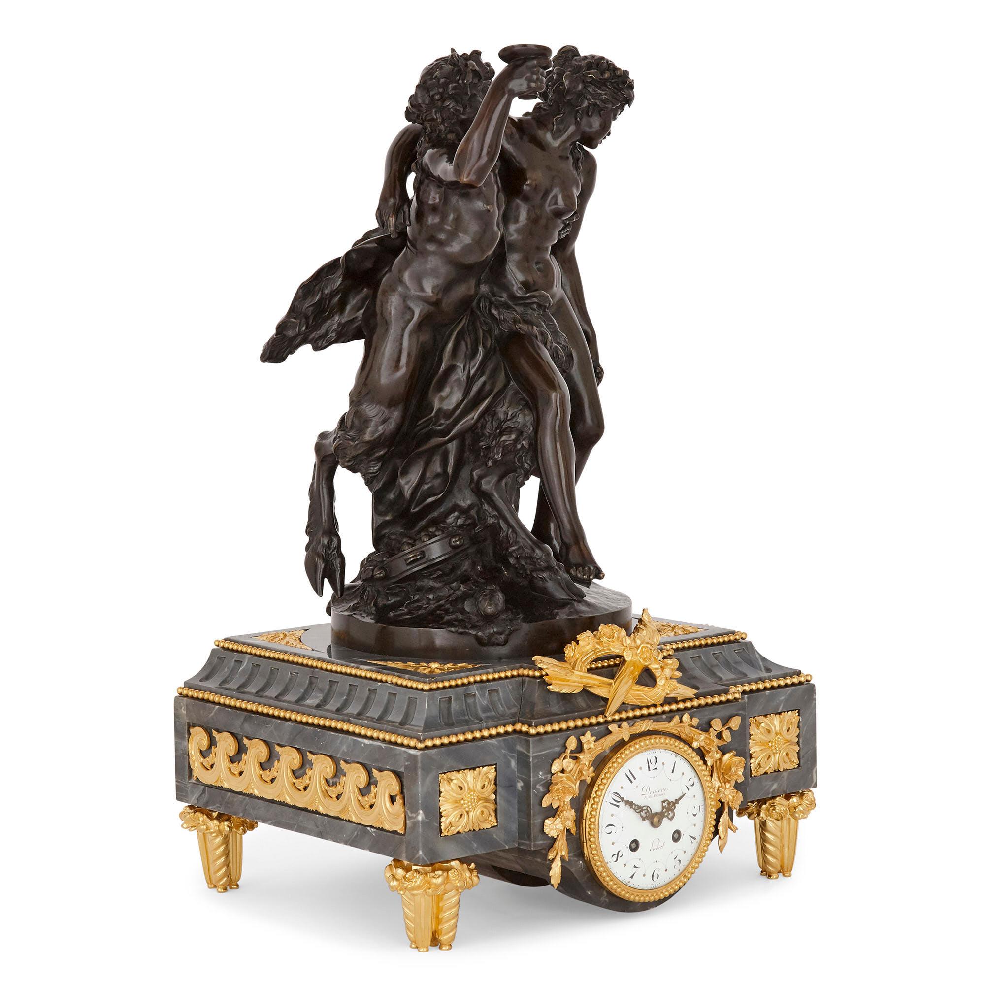 This clock set contains a mantel clock and a pair of candelabra. The central mantel clock is formed of a rectangular gilt bronze mounted grey marble base. Raised on four gilt bronze feet, the base is set to the front with an enamel dial, the hours