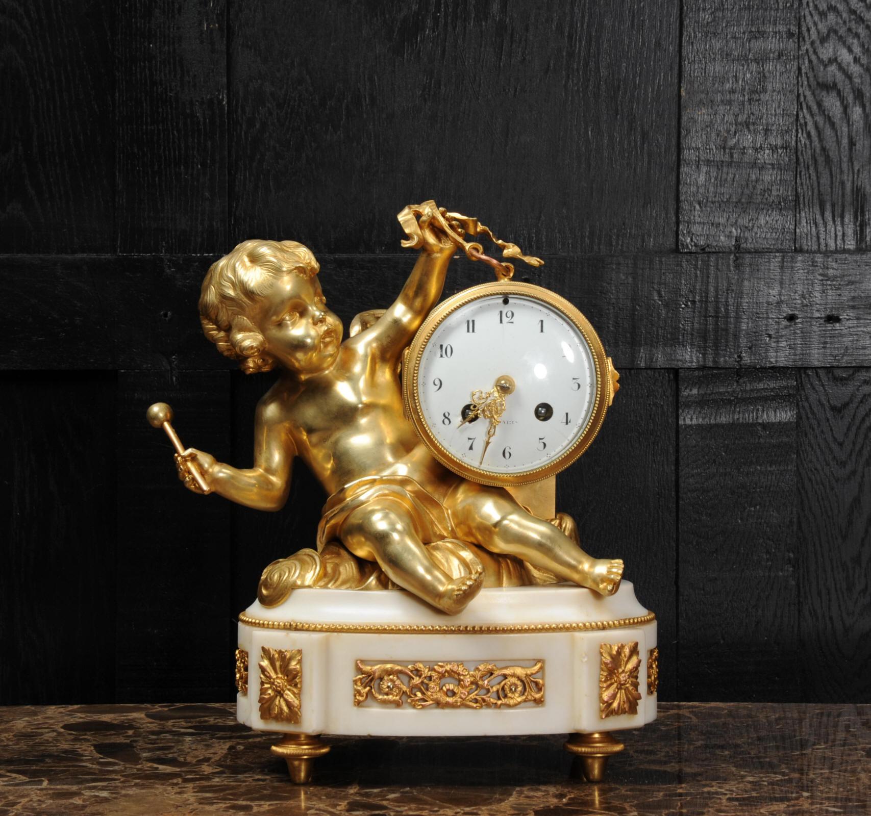 A superb original antique French clock, circa 1880. It is finely modelled in the Rococo manner with a putti floating in the clouds holding the clock modelled as a drum by a ribbon. In the other hand he is about to beat the drum. Beautifully made and