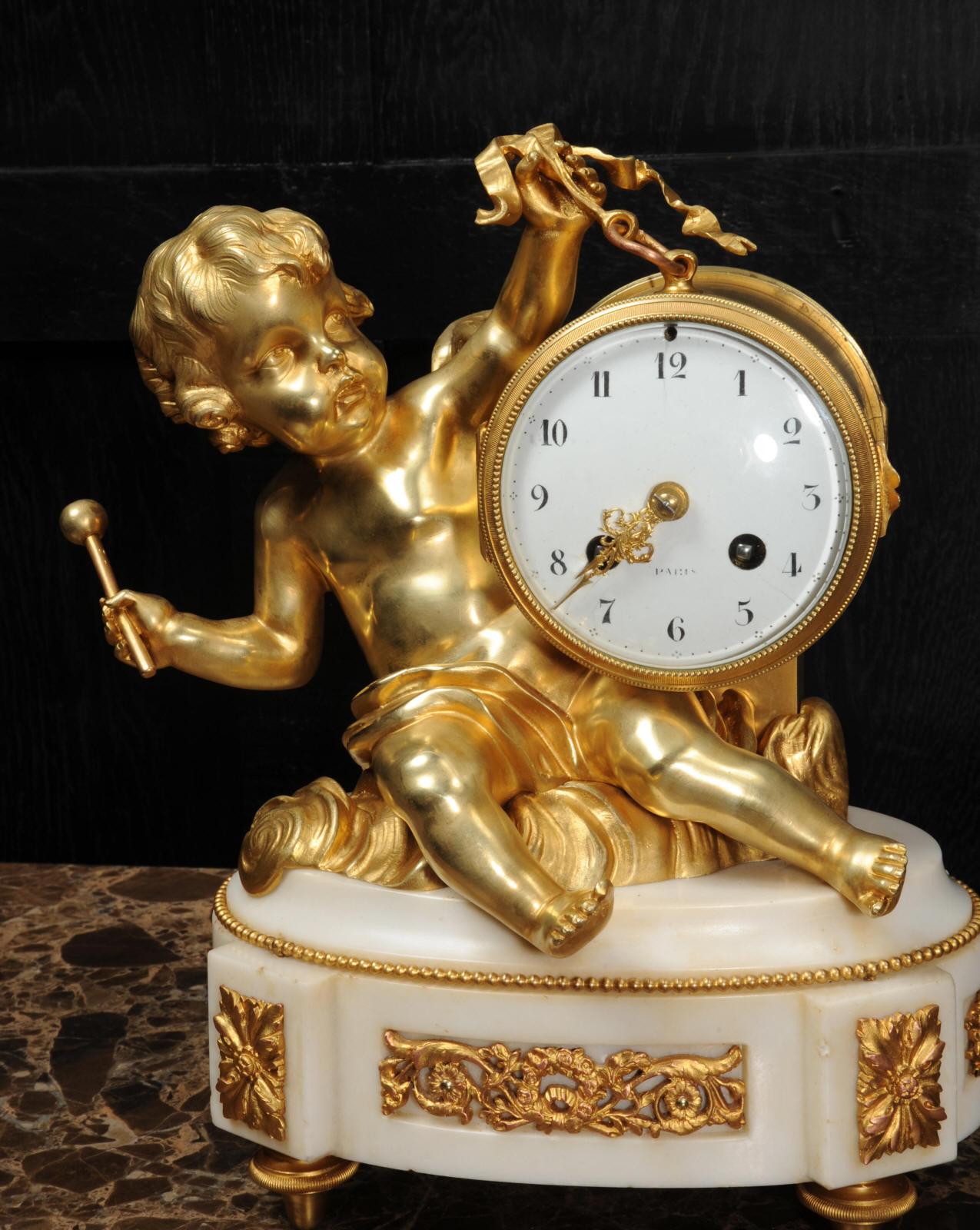 Bronze Ormolu and White Marble Antique Clock, Putto Floating in Clouds Playing a Drum