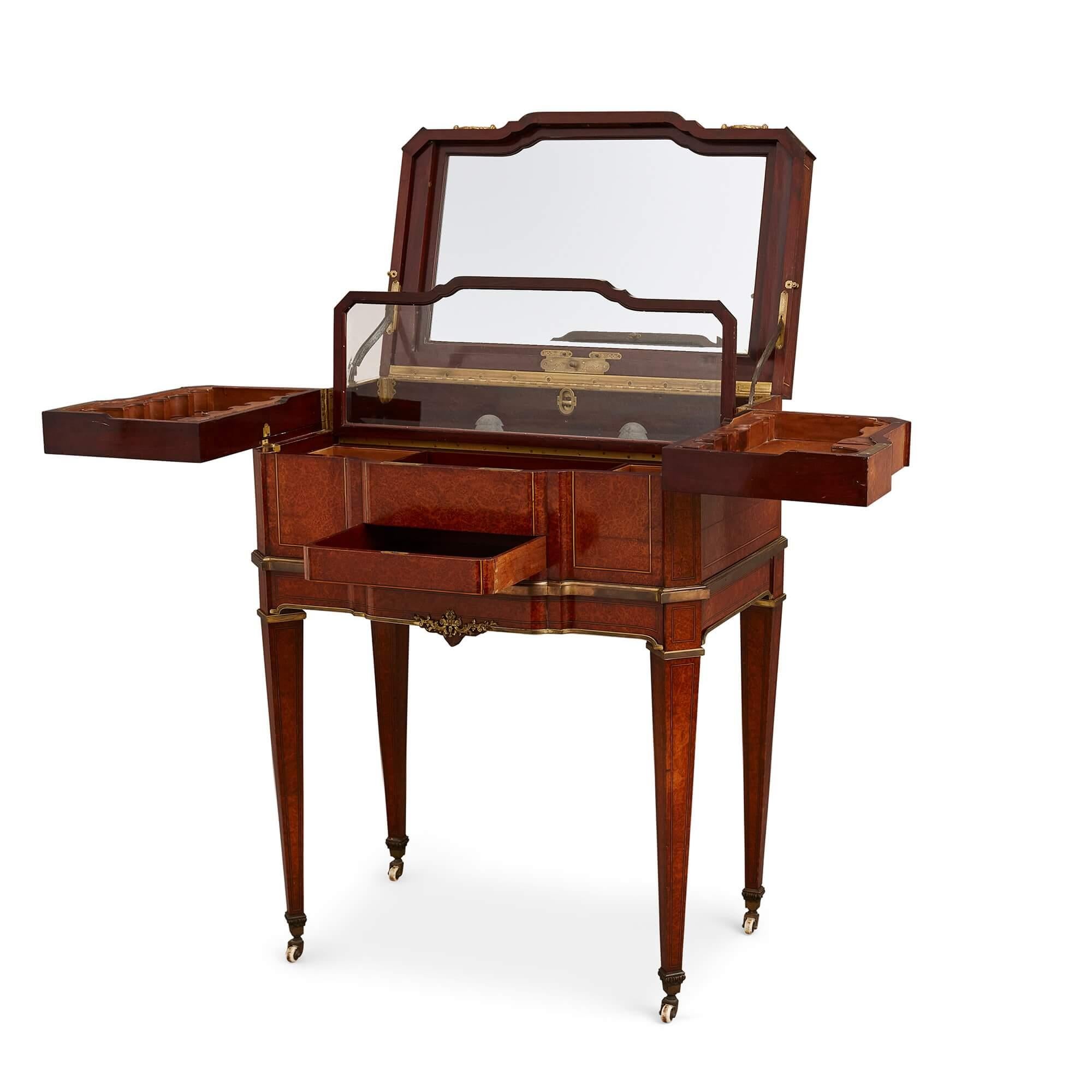 Ormolu mounted amboyna and mahogany Louis XVI style antique dressing table
French, late 19th century
Measures: height 91cm, width 70cm, depth 44.5cm

Beautiful crafted from an array of precious, richly veneered woods and mounted with elegant