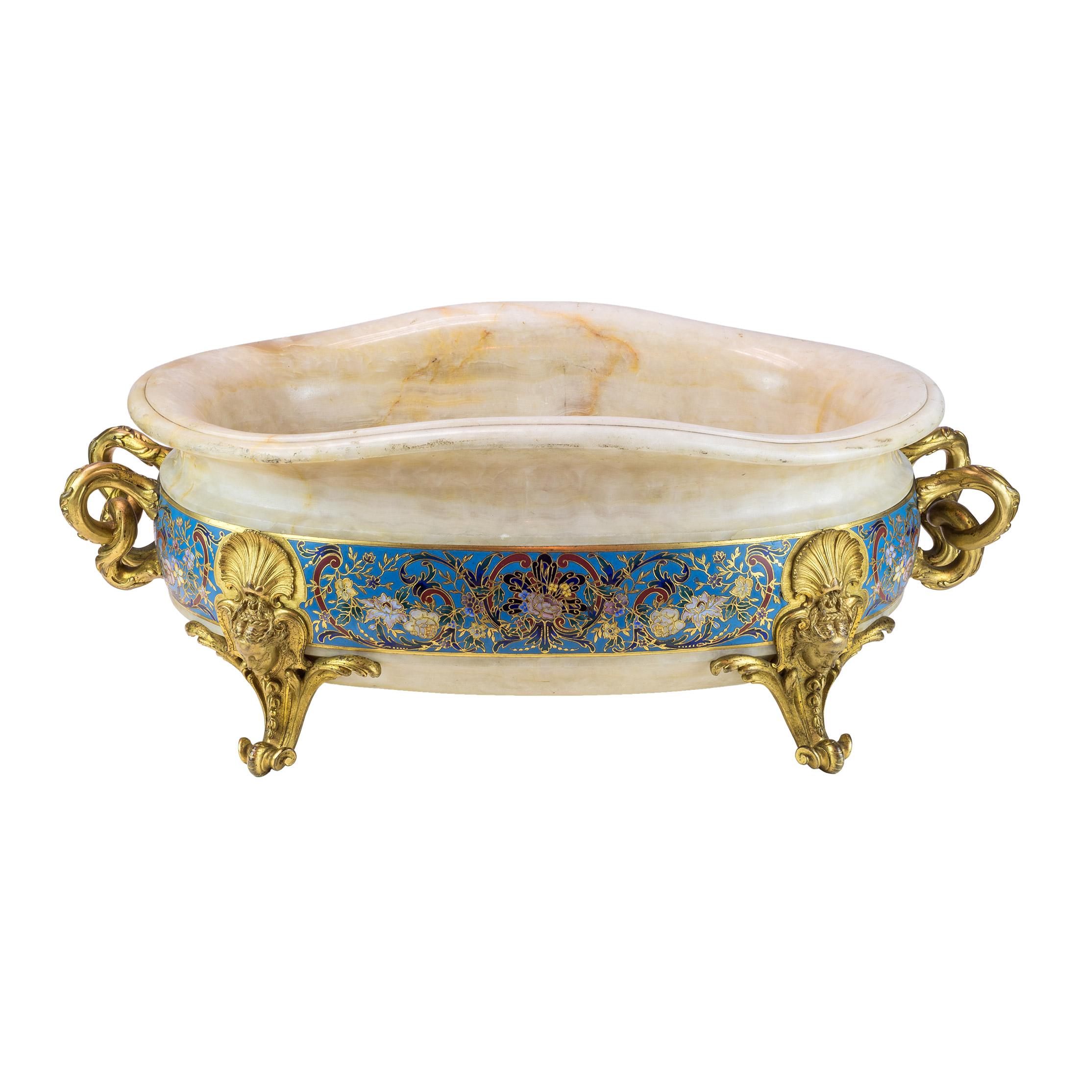 A fine quality large Neo-Grec gilt bronze-mounted and Champlevé enamel decorated onyx Jardinière by F. Barbedienne

Maker: Ferdinand Barbedienne (1810-1892)
Origin: French
Date: Third quarter 19th century
Dimension: 8 1/2 in x 22 1/4 in x 13 in
