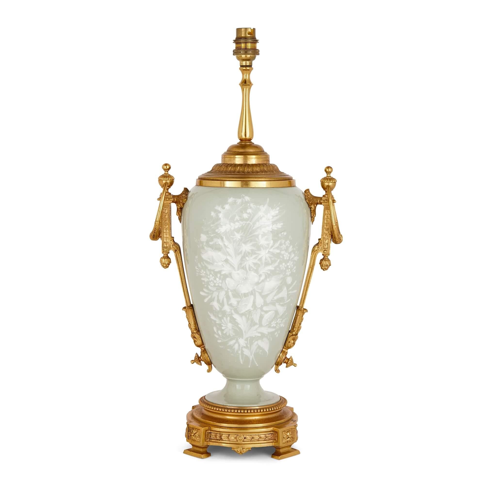 Ormolu mounted celadon porcelain and pâte-sur-pâte vase-form lamp
French, Late 19th Century
Measures: height 52cm, width 23cm, depth 17cm

Consisting of gilt-bronze handles and mounts, pâte-sur-pâte floral sprays on front and back, and a celadon