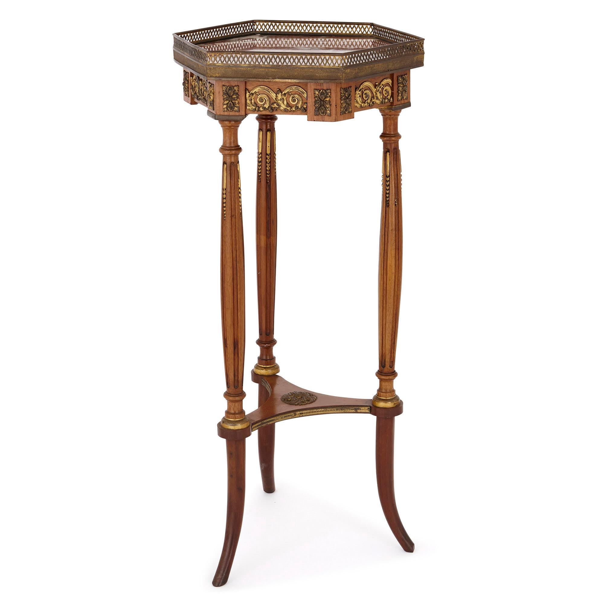 This side table is a wonderful piece of French 19th century furniture, unique for its hexagonal top and three-legged support. The table is designed in the Louis XVI style of the 18th century, which was fashionably revived in this period. 

The