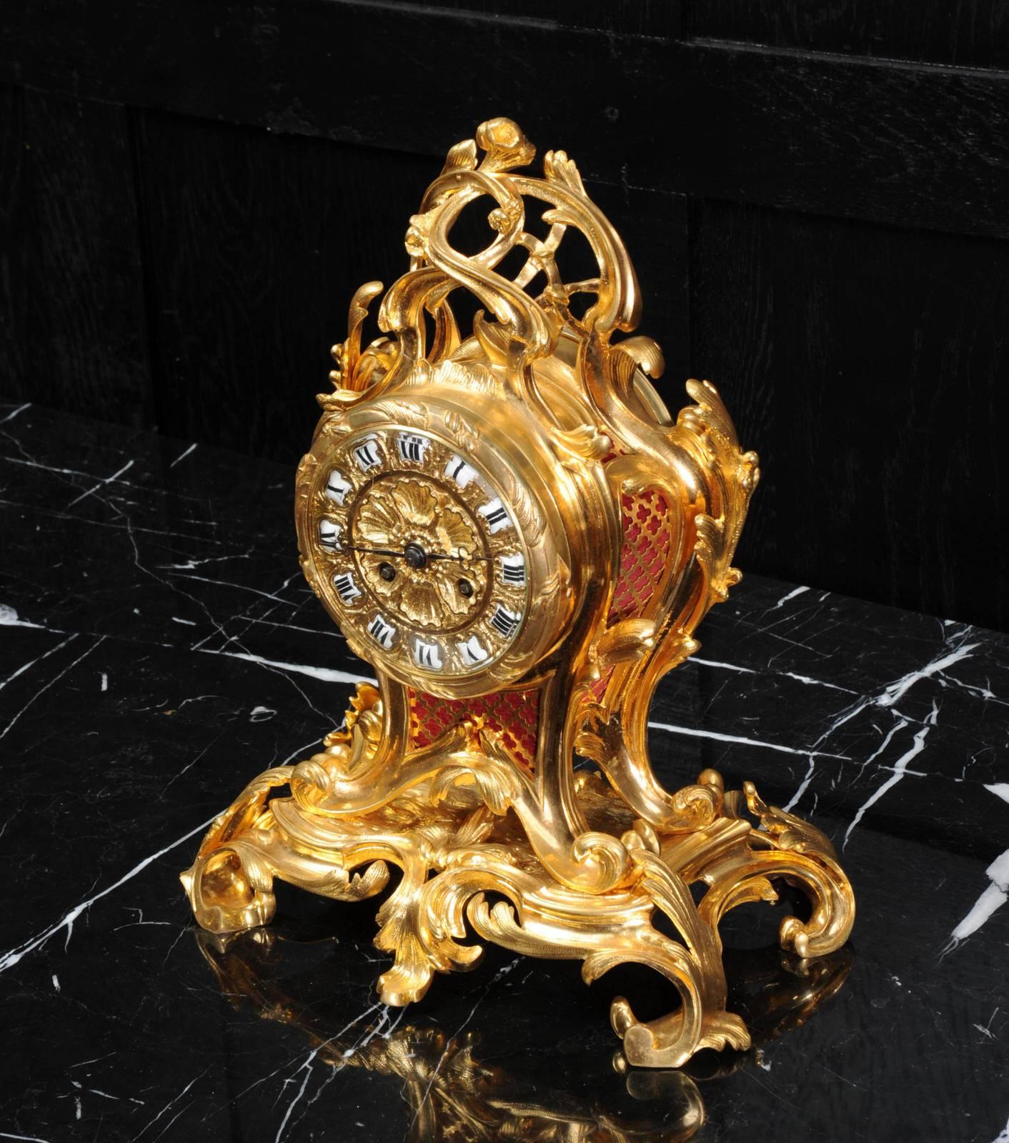 A beautiful original antique French Rococo table clock by the celebrated bronze foundry of Charpentier et Cie. It is finely made in gilded bronze, boldly sweeping curves of leaves rise to a twirling finial. The dial is deeply molded with sea shells