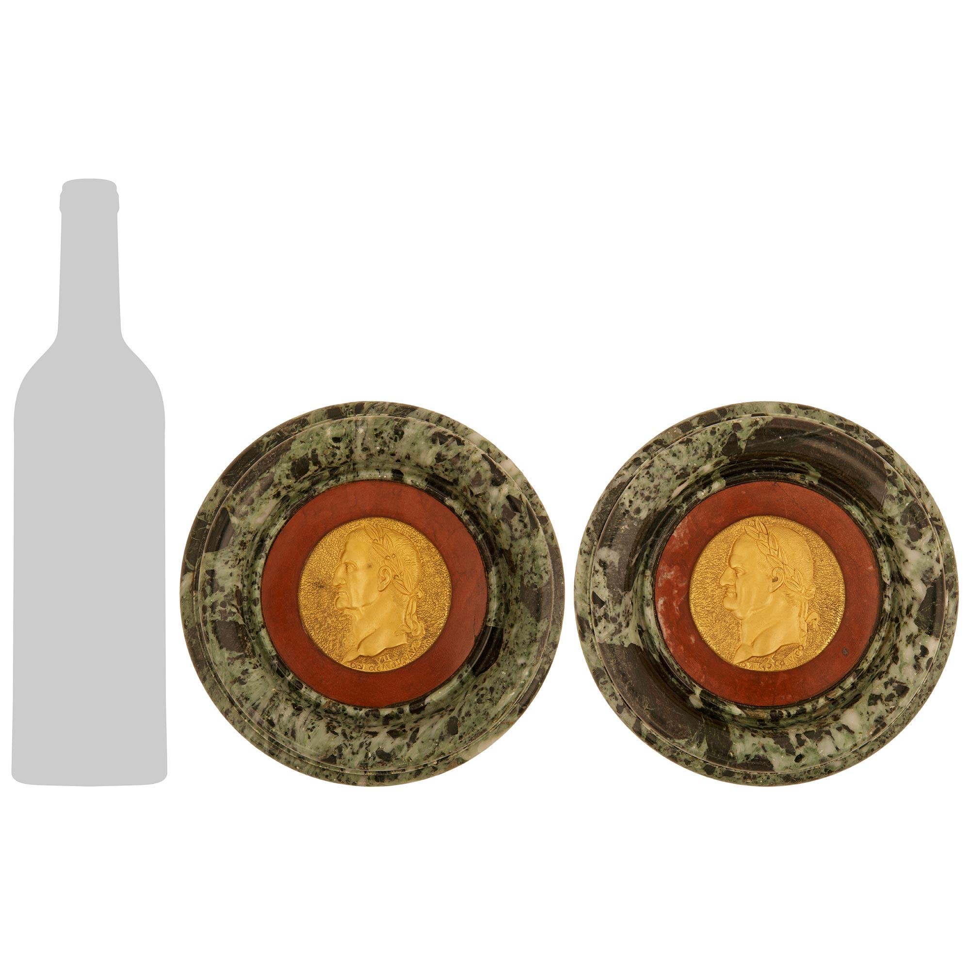 A striking and most decorative pair of Italian 19th century Ormolu, Vert de Patricia, and Rosso Antico marble Roman Emperor plaques. Each stunning circular plaque is set on an impressive circular outer Vert de Patricia marble mottled frame with an