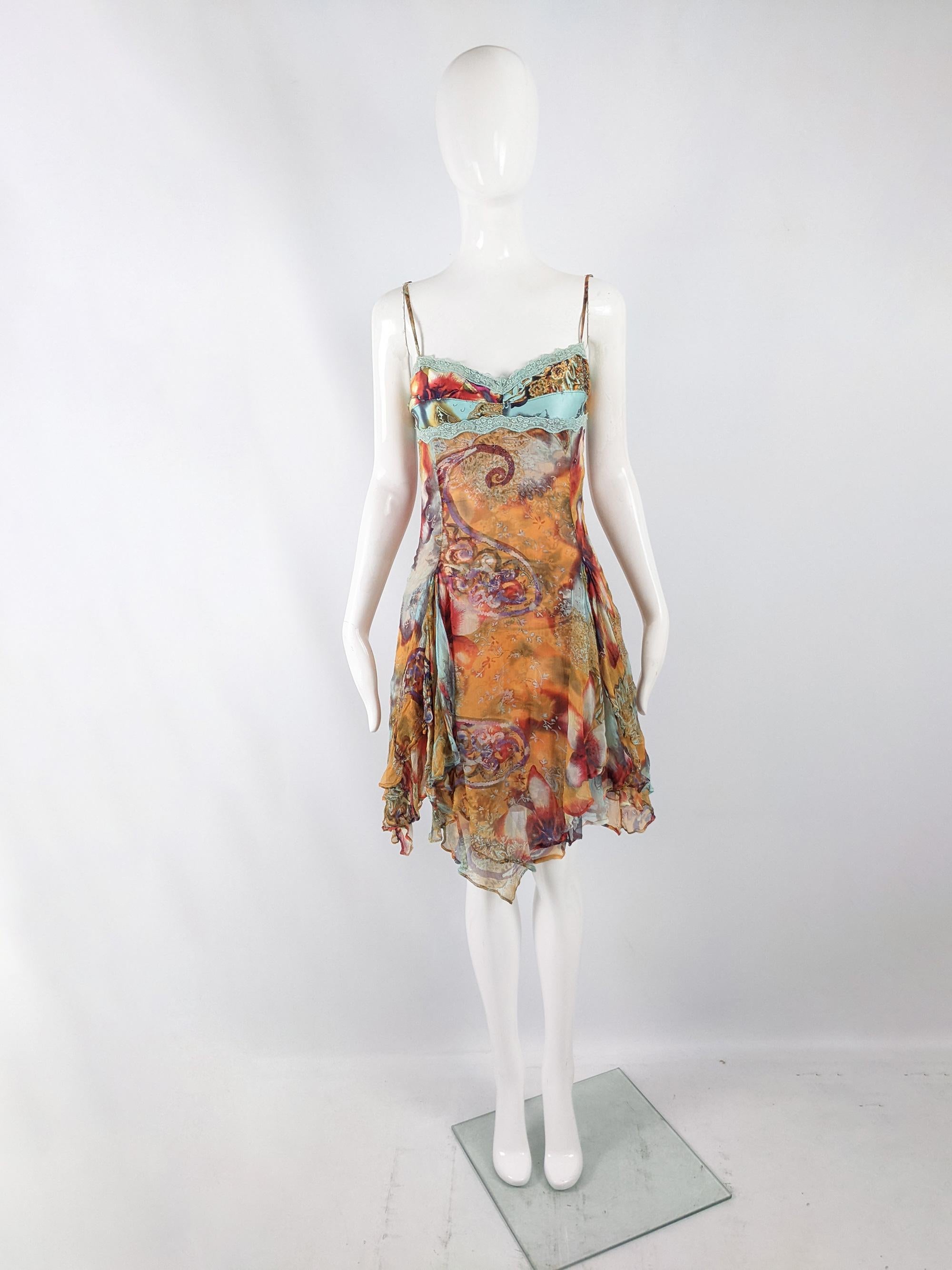 A sexy vintage womens dress from the late 90s / early 2000s by luxury Parisian fashion designer, Orna Farho. In an orange pure silk chiffon fabric, which has beautiful drape and airiness, printed with an abstract paisley and floral print. It is