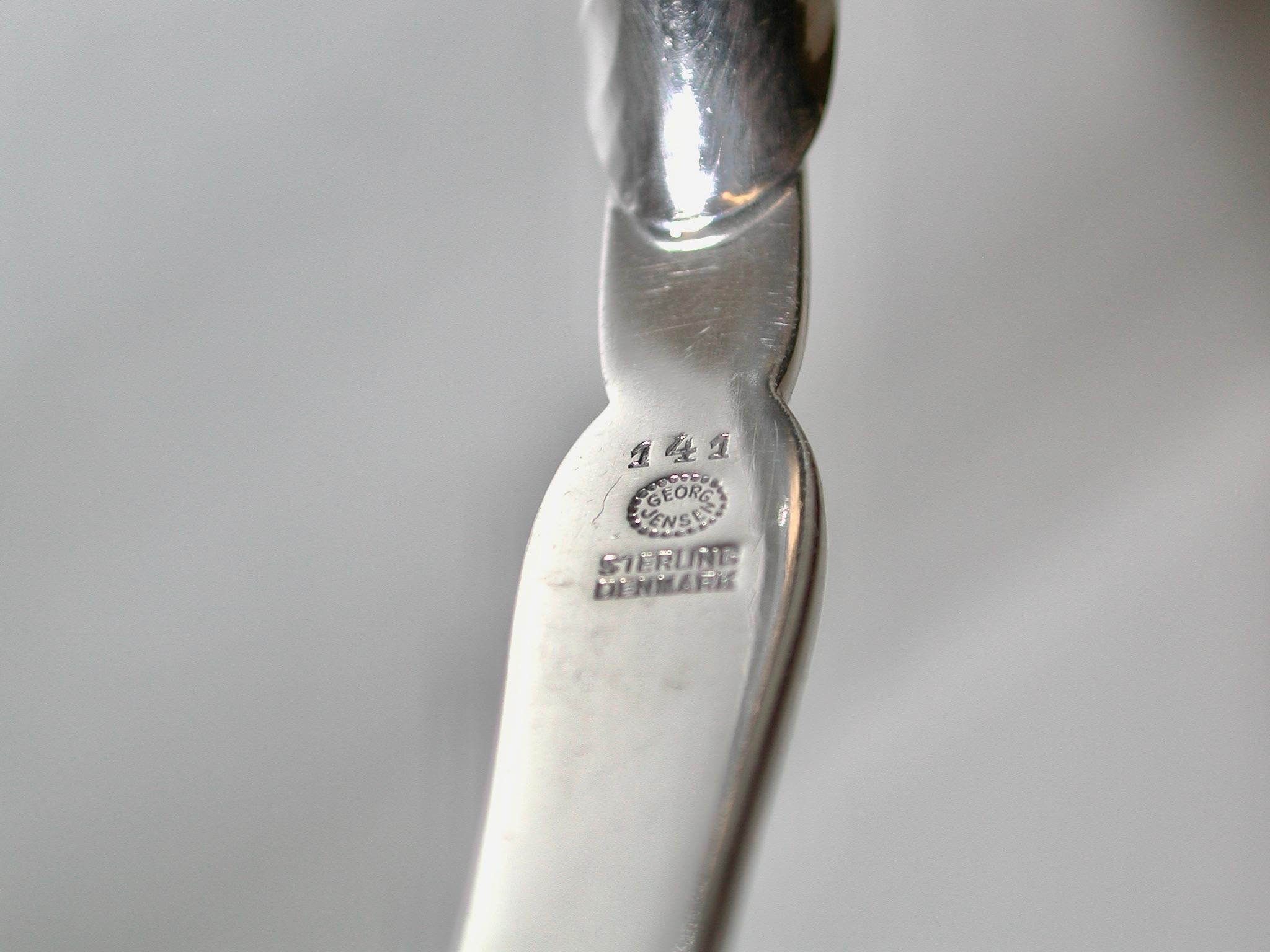 Ornamental Georg Jensen Sterling Silver Serving Spoon Circa 1950
 This beautiful spoon measures 8 inches long and has a design no.141, 
 Which shows lovely leaf and stamen work.
 