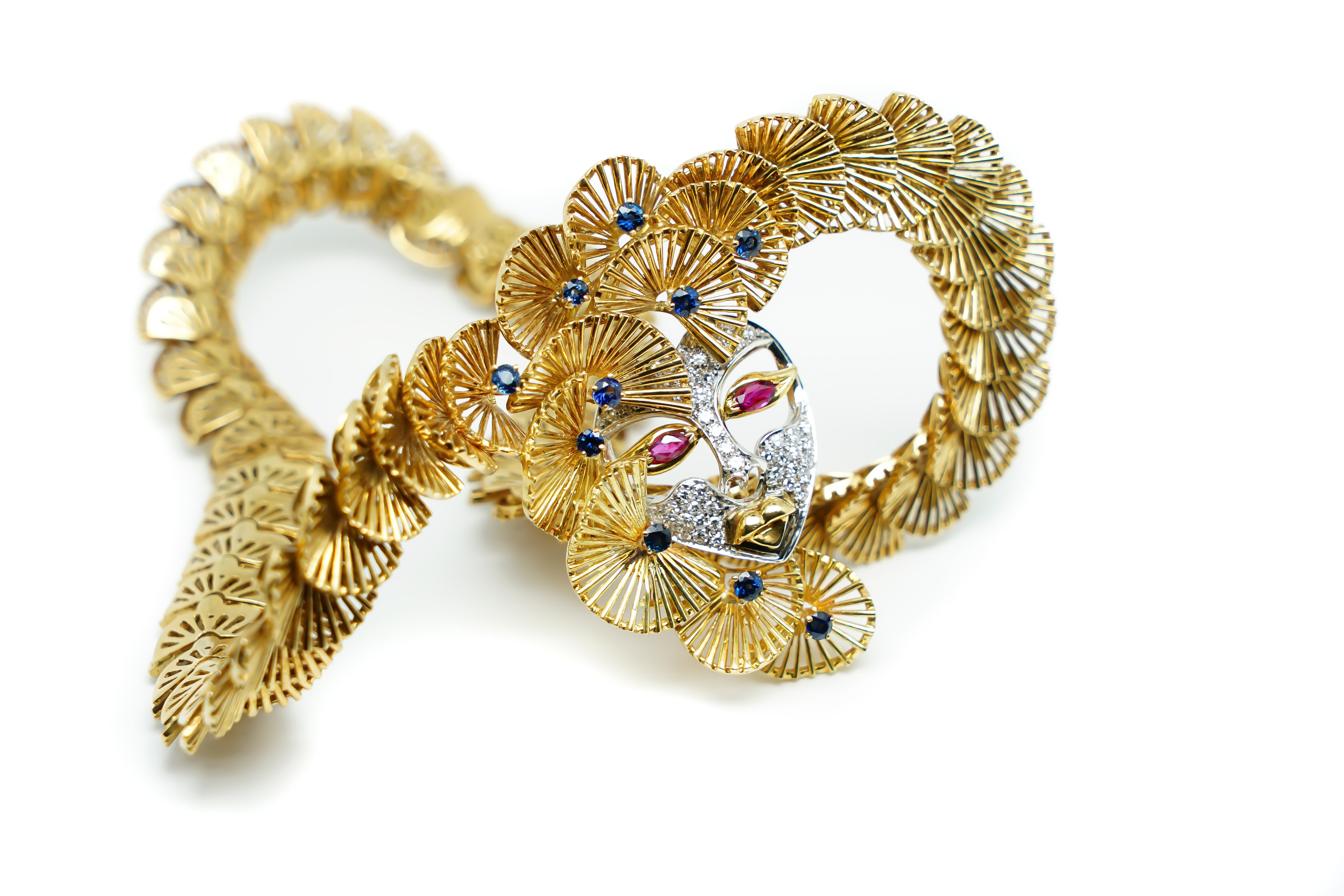 Ornamental and Sculptural Necklace 18 Karat Gold, Sapphires and a Mask filled with Rubies and Diamonds. It's a piece that has a very Elaborated and Original Design with a beautiful detailed structure totally Handmade that makes it Unique and a real