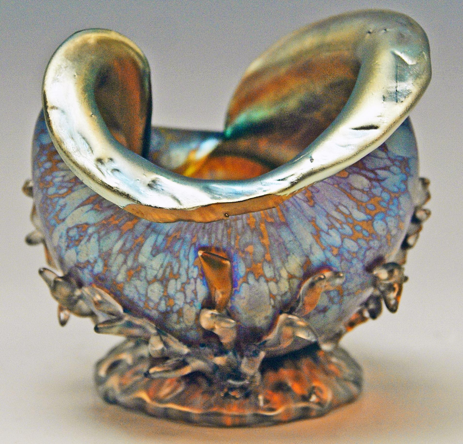 Superb Art Nouveau ornamental vase shaped as snail.

Made by Loetz, Klostermuehle (Bohemia), circa 1900.
Decor: Candia Papillon

It is a nicest Loetz Vase of this very special form type of a snail:
Blow-molded as well as colorless glass with
