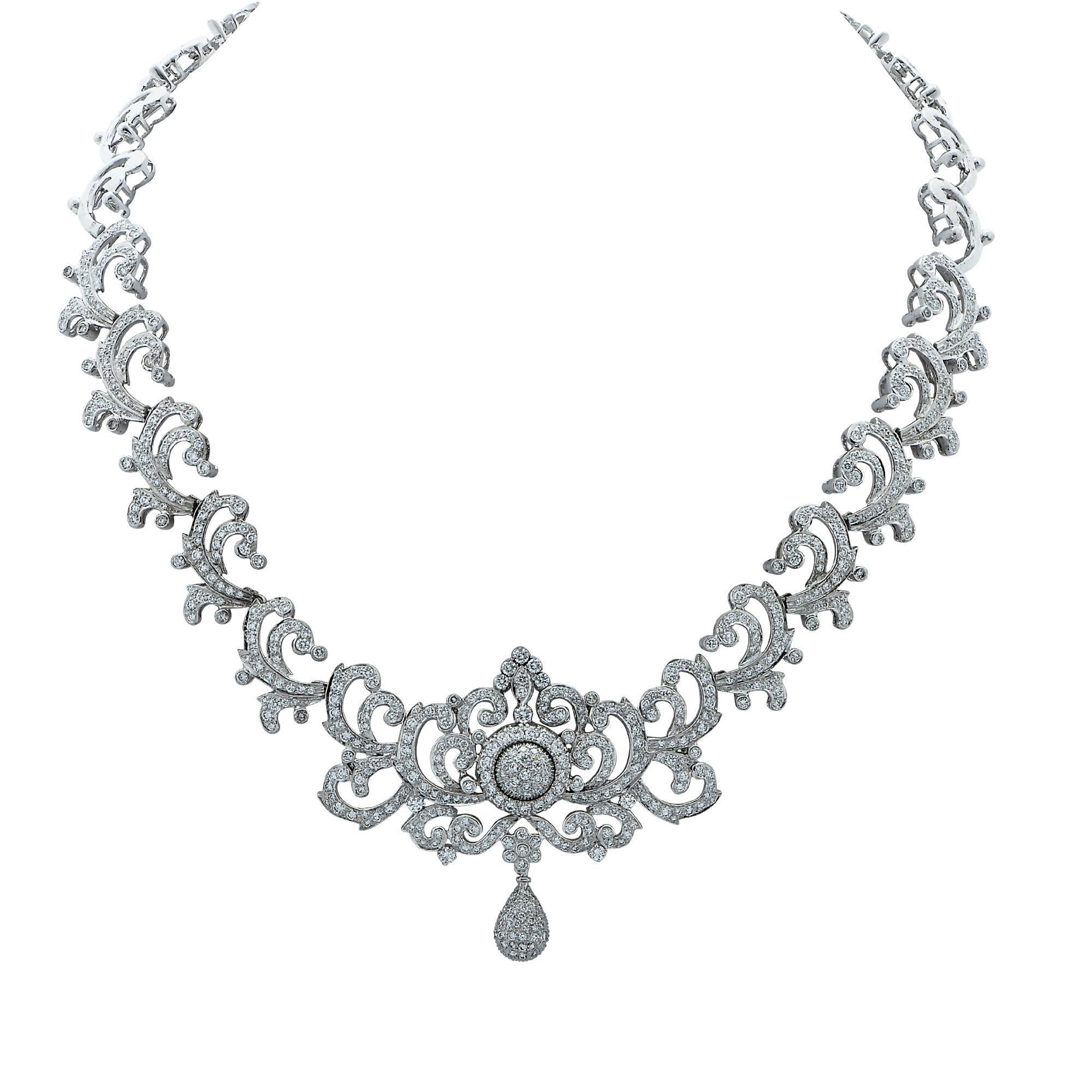 Ornate baroque inspired 18K White Gold necklace and earring set featuring 10.83cts of round brilliant cut diamonds G-H color and VS-SI clarity, expertly crafted in a diamond adorned thorn and leaf motif, culminating in a dangling diamond encrusted