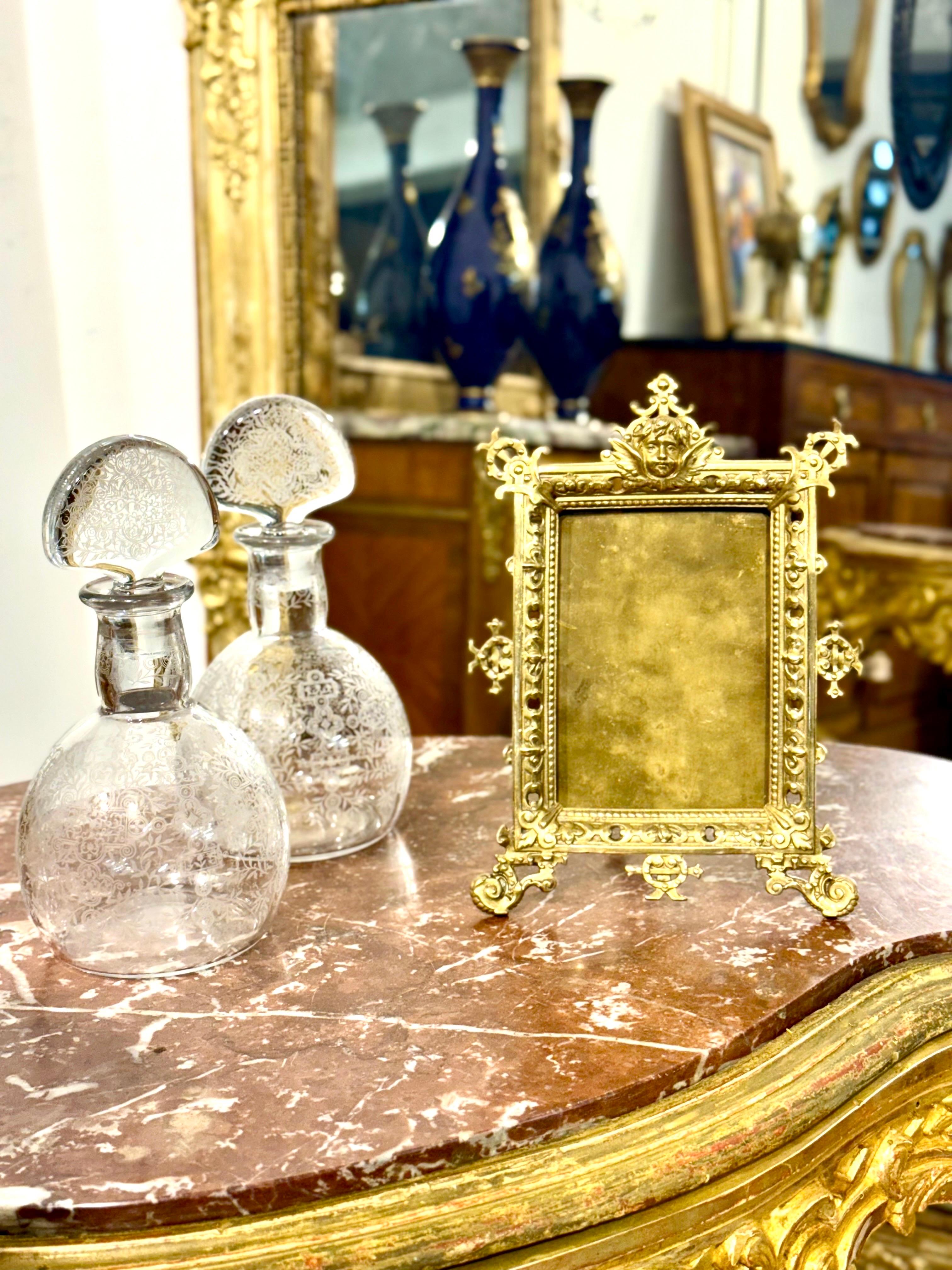 This magnificent 19th-century gilt bronze tabletop frame is a beautifully detailed decorative object that embodies the refinement and artistic exuberance of the late Victorian and Belle Époque periods. Crafted in solid gilt bronze, it features a