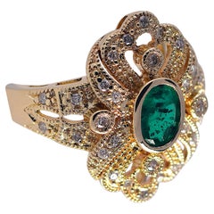 Ornate .52 Carat Emerald and .21 Carat Diamond Fashion Ring. 14 Karat Gold