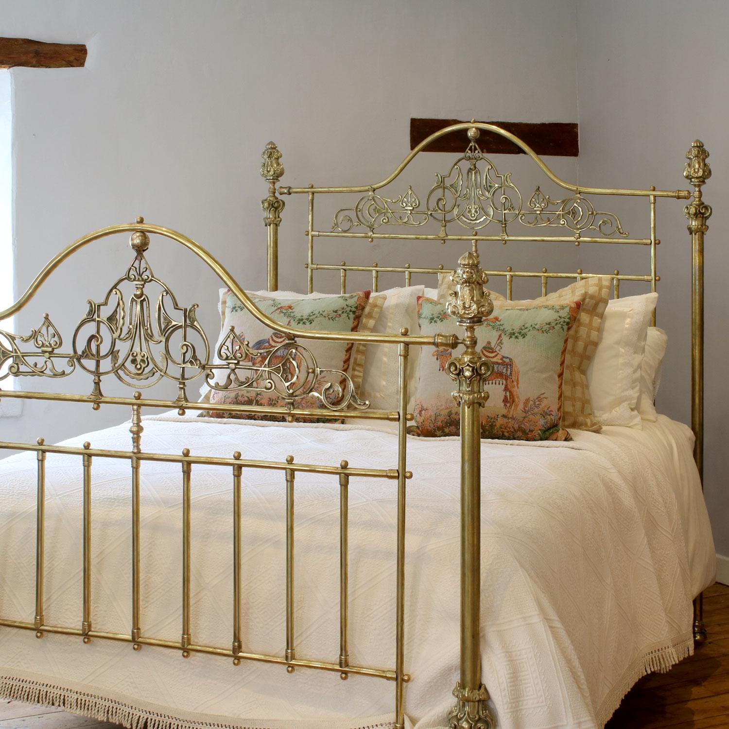 A superb top quality all brass Victorian antique bed with serpentine brass top rail, intricate brass castings on the head and foot end, ornate brass fittings on the posts and decorative knee caps. 

This bed accepts a 5ft wide (60in or 150cm) base