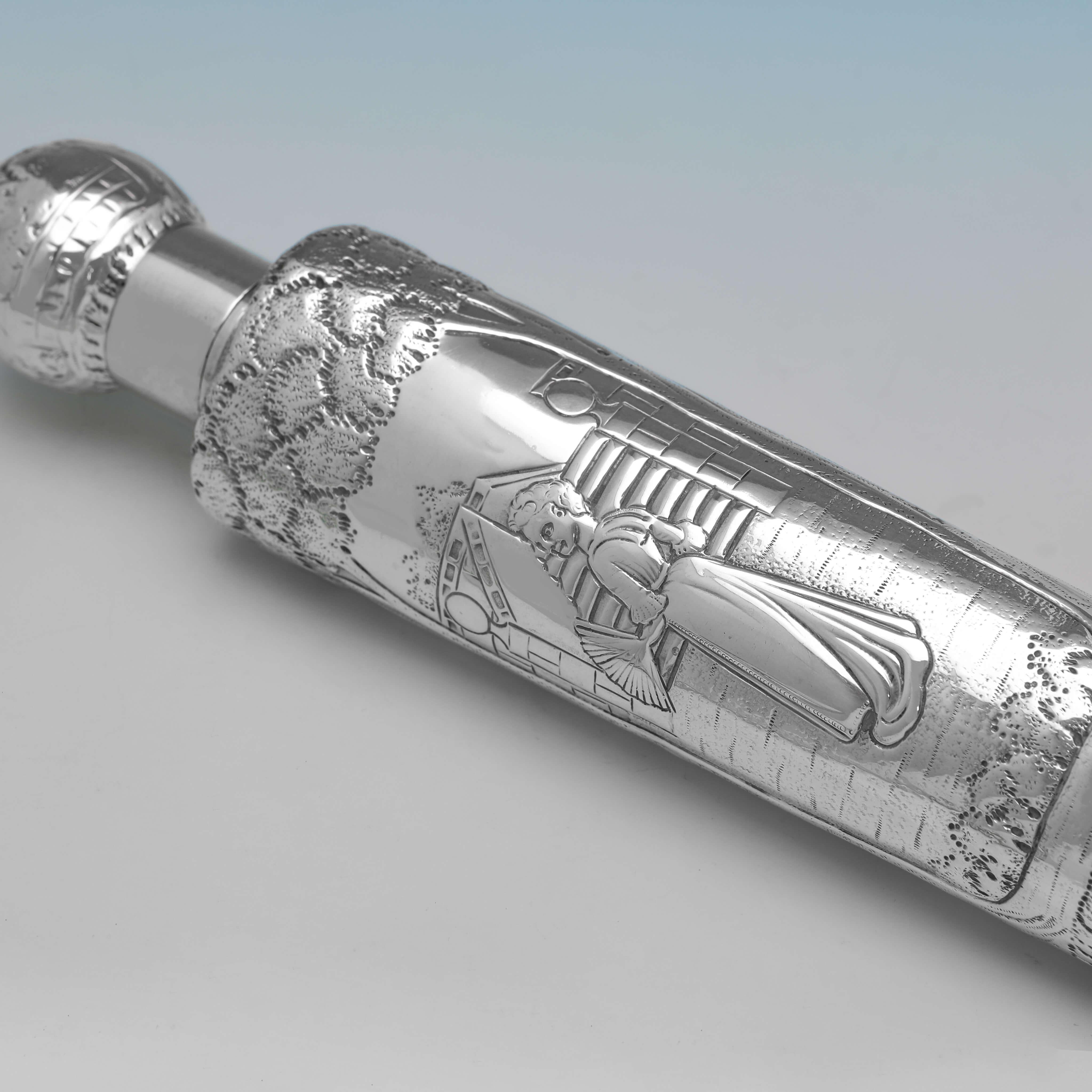 Hallmarked in London, 1896 by Samuel Jacob, this attractive, Victorian, Antique, Sterling Silver Scent Bottle, features wonderfully chased scenes throughout, and a removable lid. 

The scent bottle measures 15.5 inches (39.5cm) in length, and weighs