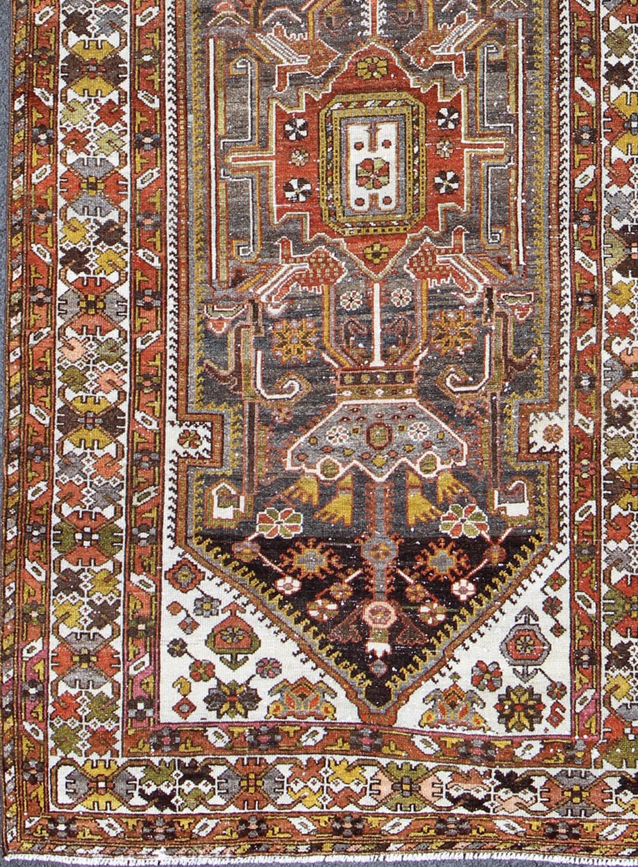 Geometric Medallion Design Vintage Persian Bakhtiari Runner in Orange, Olive, Brown, Ivory, and Gray, rug gng-4753, country of origin / type: Iran / Bakhtiari, circa 1930

Persian Bakhtiari rugs are in fact tribal pieces that rely upon a