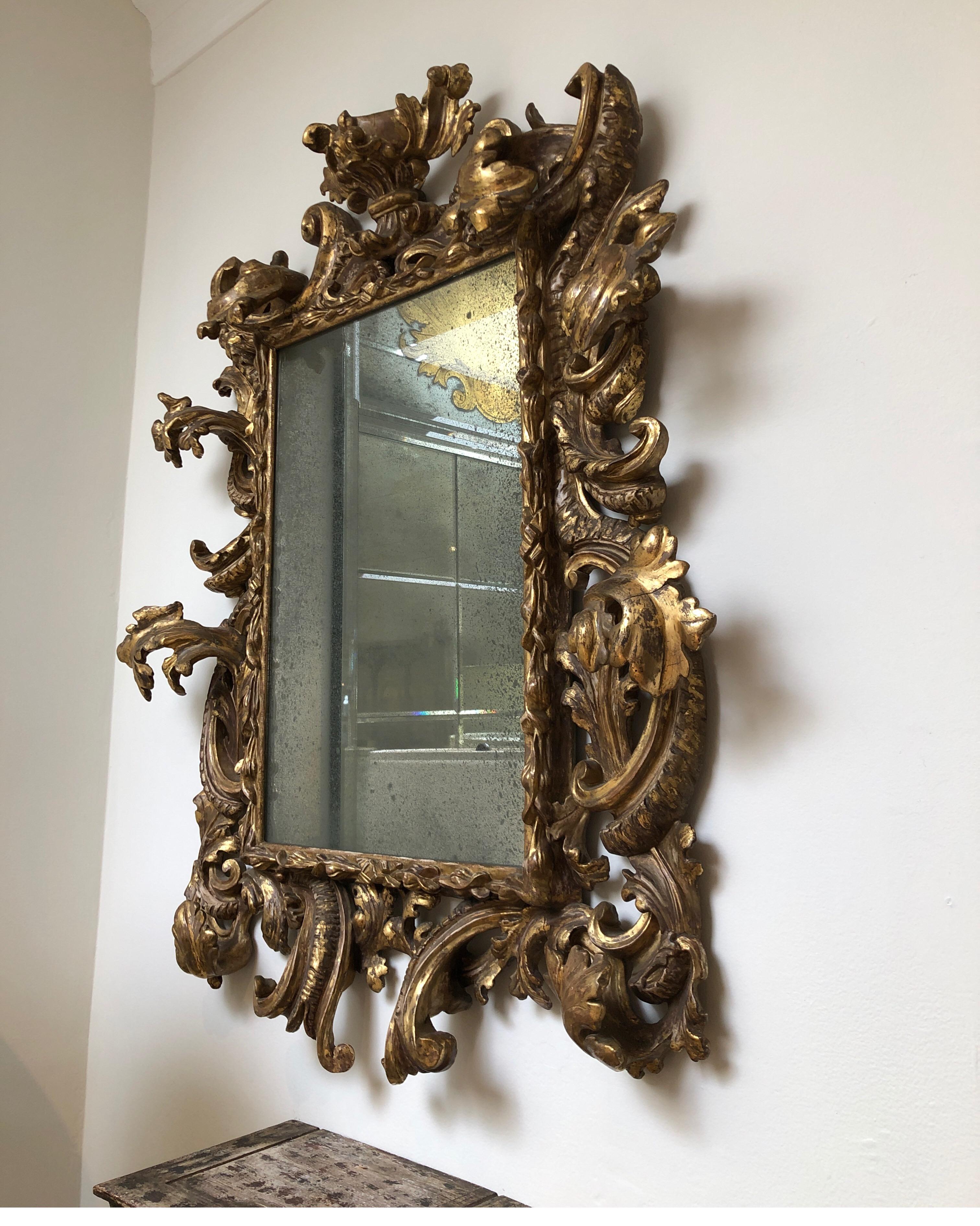 Antique gilded gold Rococo mirror with antique glass.