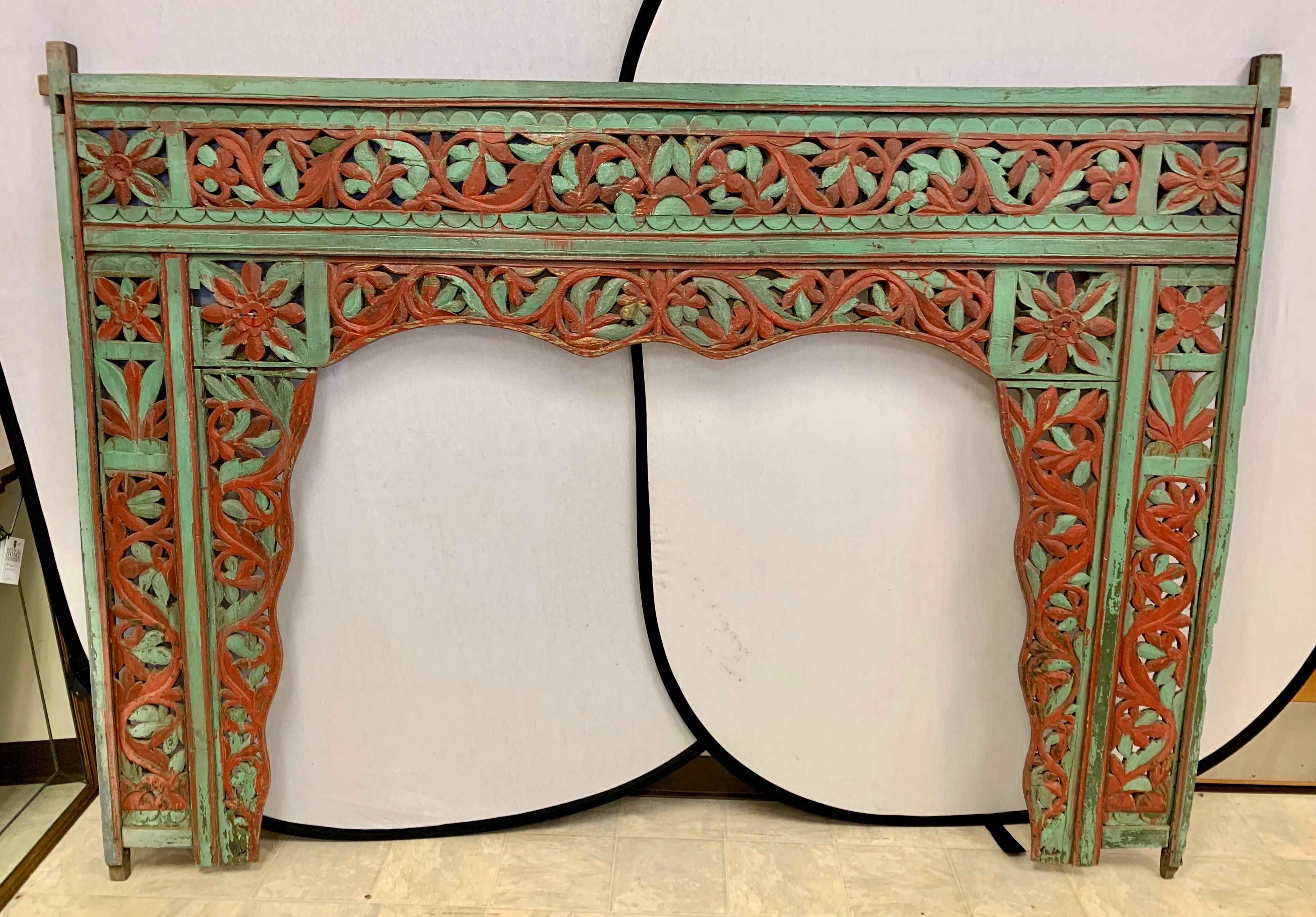 Magnificent vintage carved king headboard  from Bali, circa late 19th century that was acquired by our client via a Paris Flea market purchase back in the 1970s. The colors, green and red are quite vibrant but the intricate carved detail makes it a