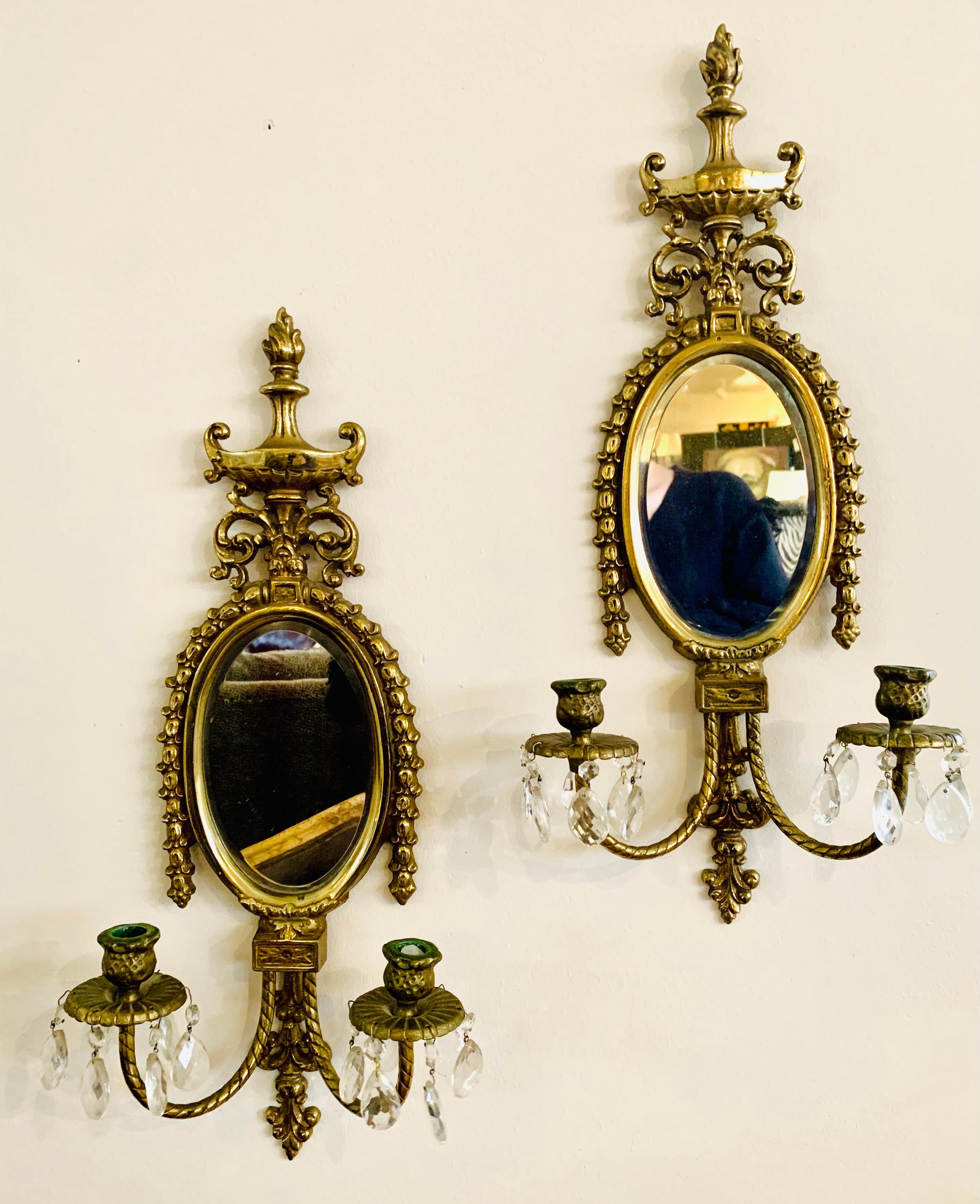 Gorgeous vintage solid cast brass wall sconces with beveled mirrors. The double candle arms detail a rope pattern. Each holds two candles and have dangling crystals.
