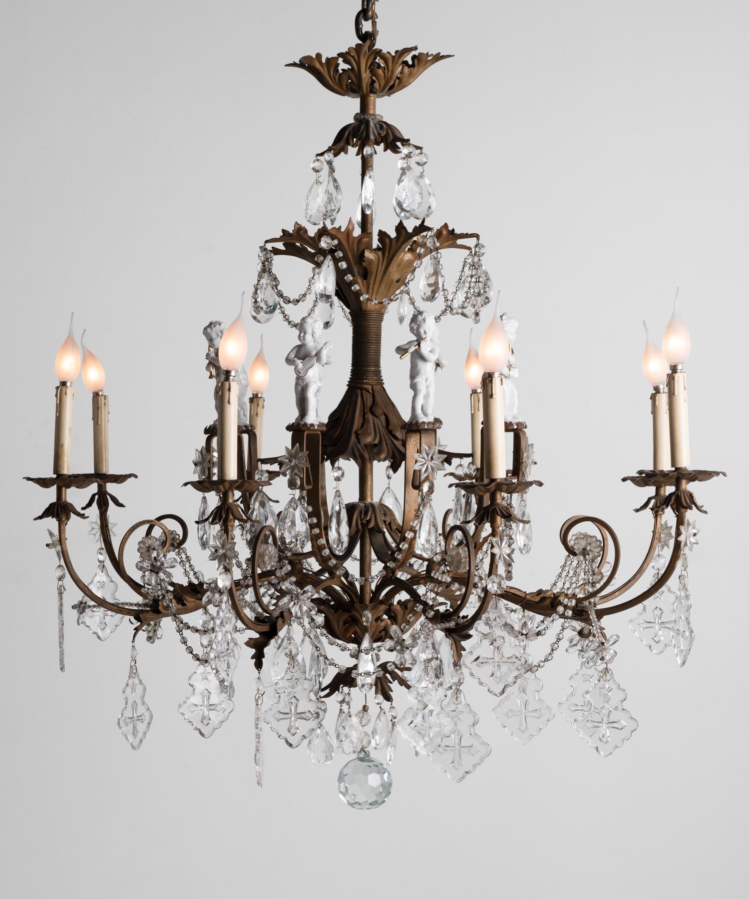Ornate Brass Chandelier with Porcelain Figures, Italy, circa 1920

An exquisite, unique form with faux candle lights, crystal decorative elements, a highly detailed, patinated brass structure, and (8) partially gilded porcelain musician figurines.