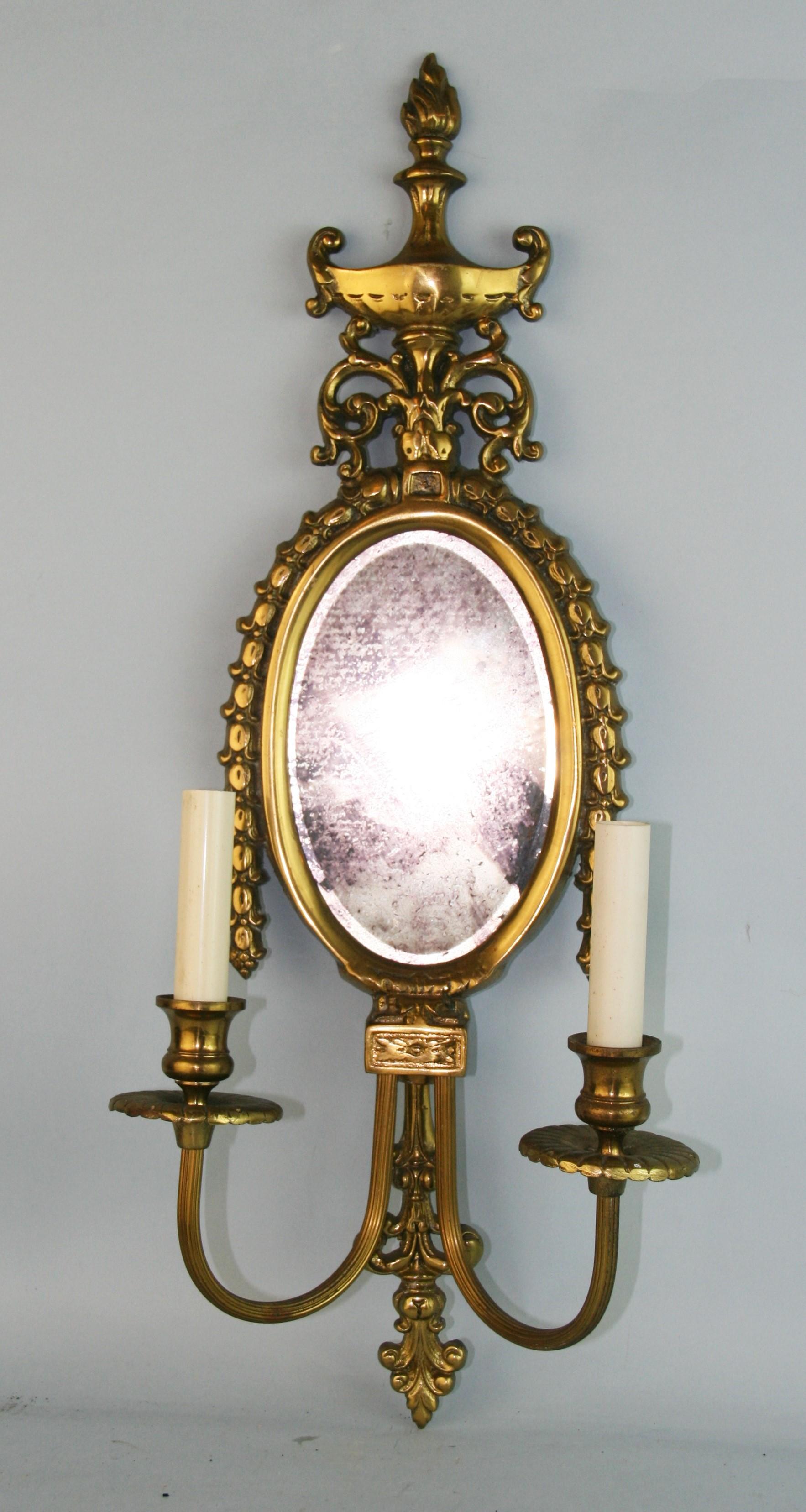 1258 Gorgeous vintage solid brass wall sconces with beveled mirror.
The double candle arms detail a rope pattern.