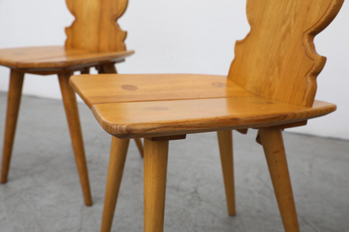 Brutalist, late 1960s, Tyrolean style pine chairs with decorative hand carved backrests. Named after the Tyrol in the Alps, a historic region encompassing Austria, Germany, Italy, and Switzerland. Because of its remote location, a unique style of