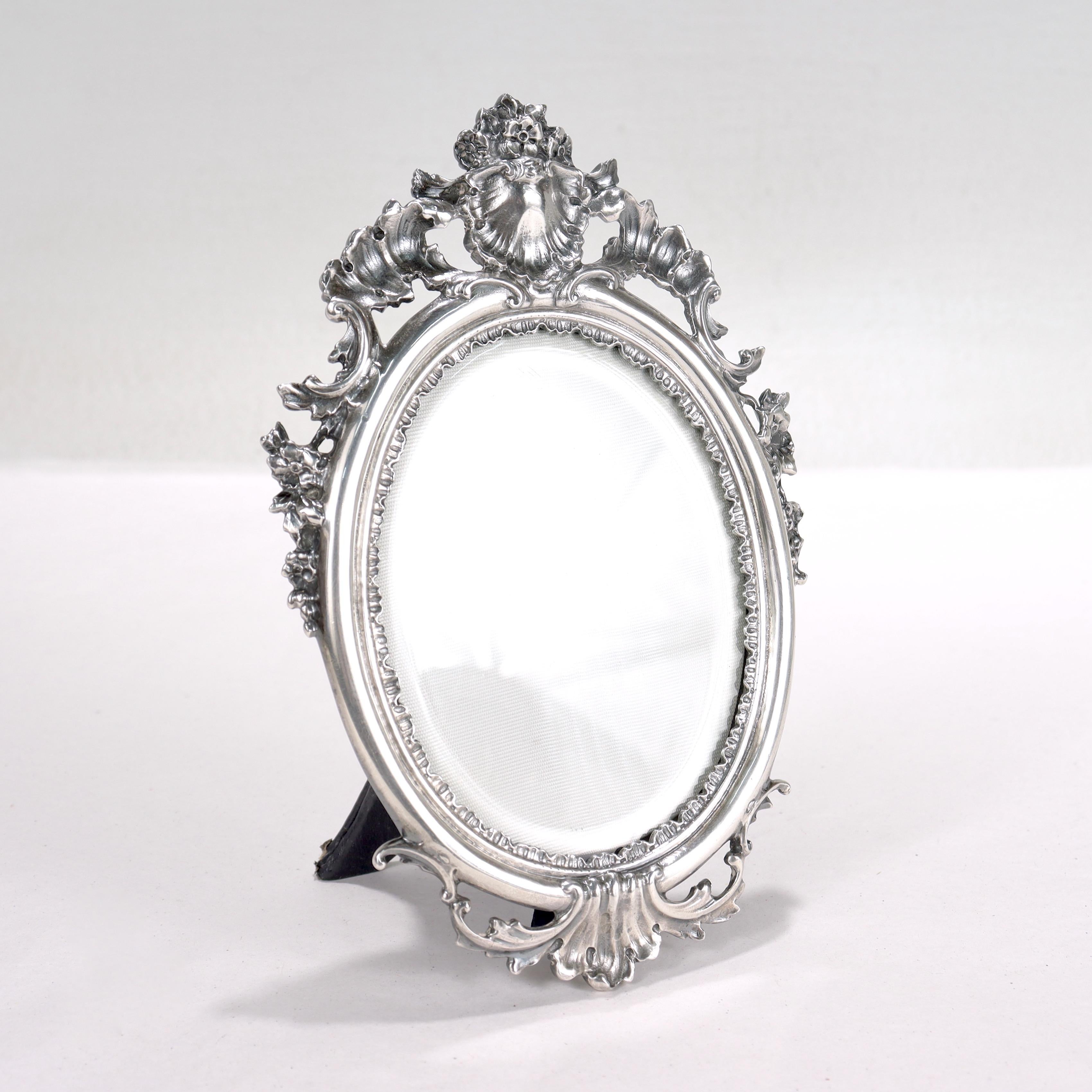 A fine silver oval, easel back picture frame.

By Buccellati.

In sterling silver. 

With heavy gauge Rococo style rocaille decoration to the top and base. 

Marked Buccellati / Italy / Sterling to the side of the frame.

Simply a great Buccellati