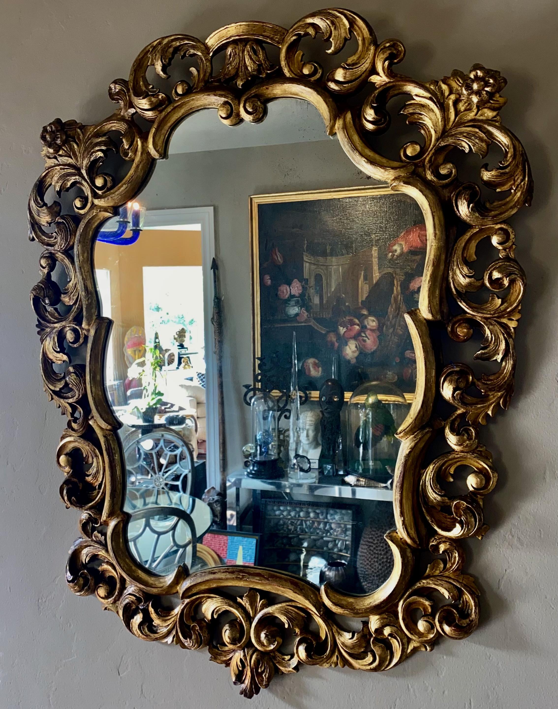 Beautifully carved wood and gilded mirror, having a C scroll and floral design, with original Fratelli Paoletti label on back.
Original refreshed finish with slightly aged original mirror.
Italy, circa 1950.
In excellent condition.
    