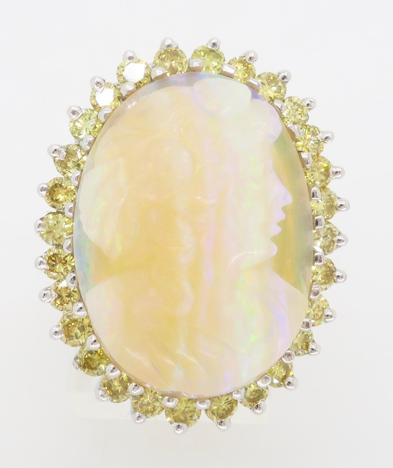 Stunning carved Opal set in a 14k yellow gold ring surrounded by 1.70CTW of Yellow Diamonds. 

Gemstone: Opal & Diamond
Diamond Carat Weight:  1.70CTW
Diamond Cut: Round Brilliant Cut
Average Color: Yellow
Average Clarity: VS-SI
Metal: 14k White