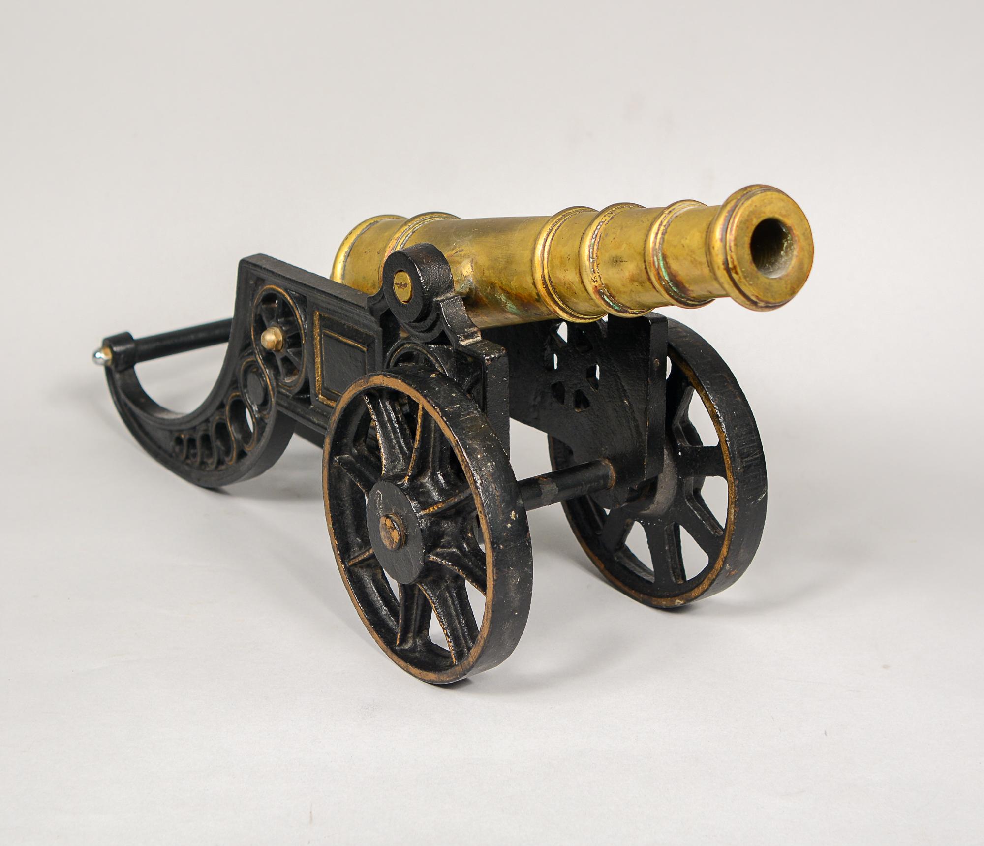 This large desk top cannon model will actually fire. The barrel is bronze and the carriage is iron. The carriage has been repainted in the past.