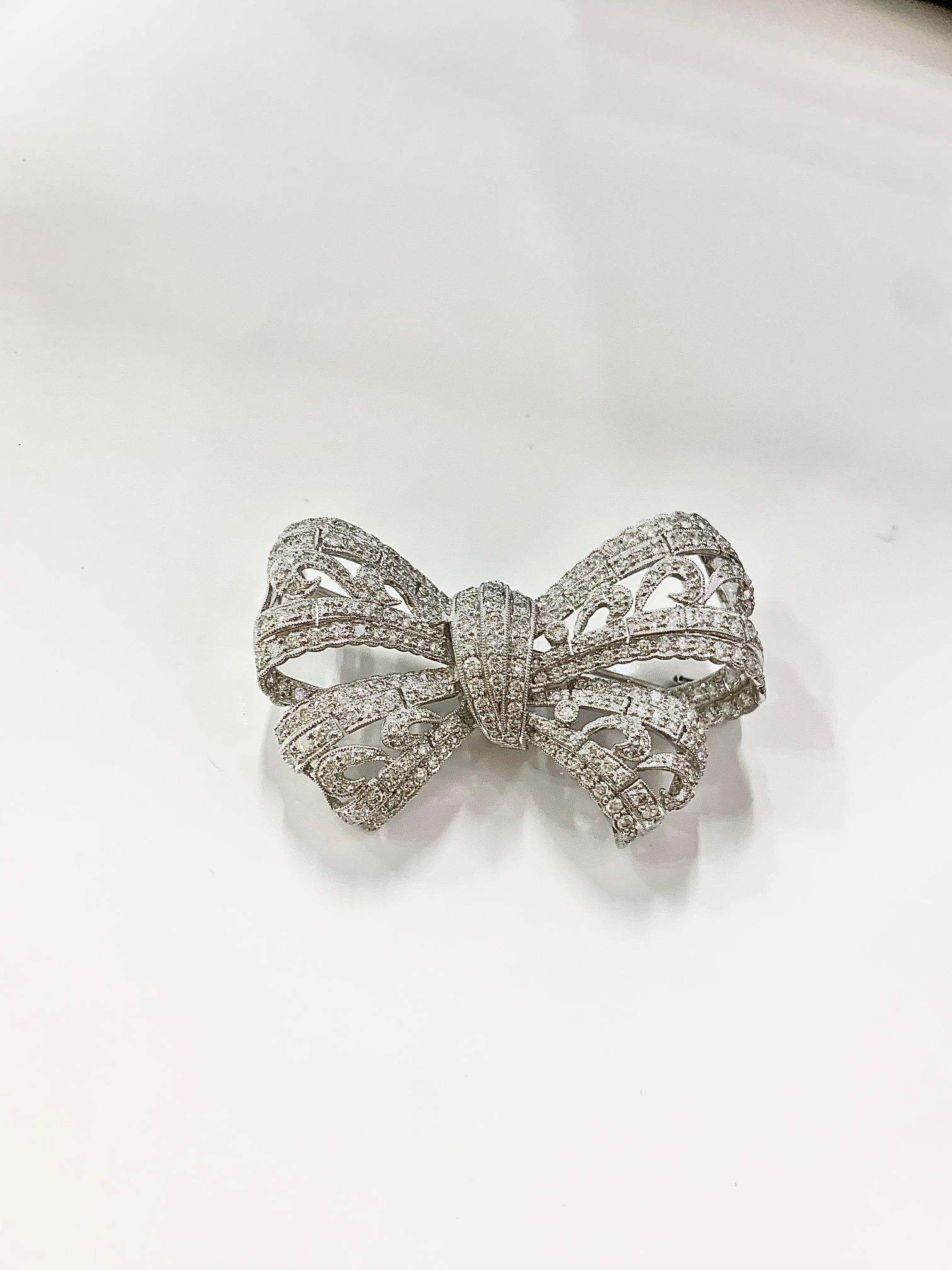 Collectors Special 3.22 Carat Bead Set Diamond Bow Brooch 

Stones: Diamond
Stone Shape: Round 
Stone Carat: 3.22 Carat 
Stone Setting Style: Bead Set 
Brooch: 18K White Gold 
Brooch Dimensions: 2 x 1.5 Inch
