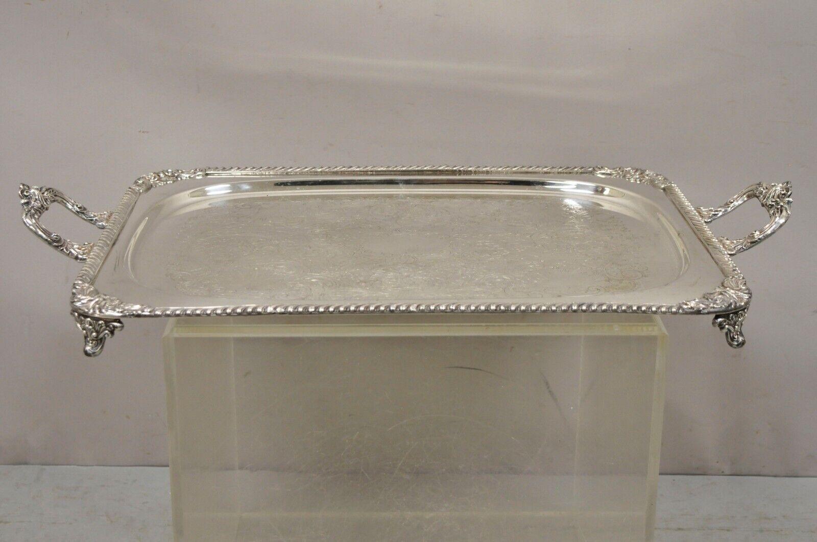 Ornate English Victorian twin handle heavy silver plate platter tray. Item features heavy silver plated construction, ornate etching to center, ornate twin handles, raised on ornate feet, original stamp, quality craftsmanship, great style and form,