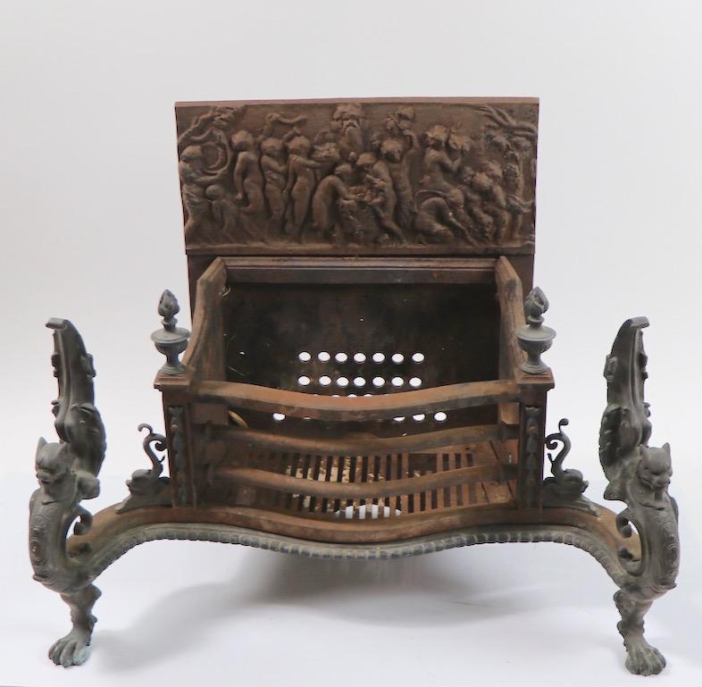 Ornate fireplace insert coal grate made by noted fireplace equipment maker Wm. Jackson (signed). The grate has a cast iron back with classical figures in relief, iron body and large solid brass griffins as front legs. This example was originally