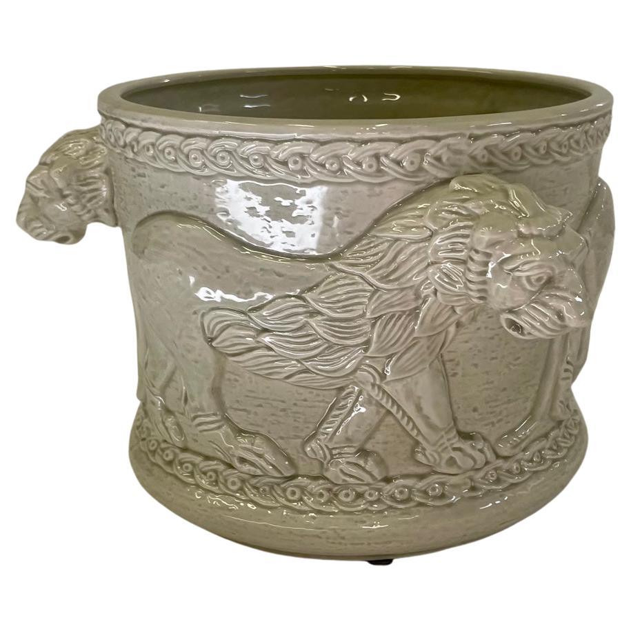 Beautiful detailed ceramic planter having protruding lion heads that act as fabulously integrated handles. Signed Fitz & Floyd on bottom. Opening is 7.75 diameter.