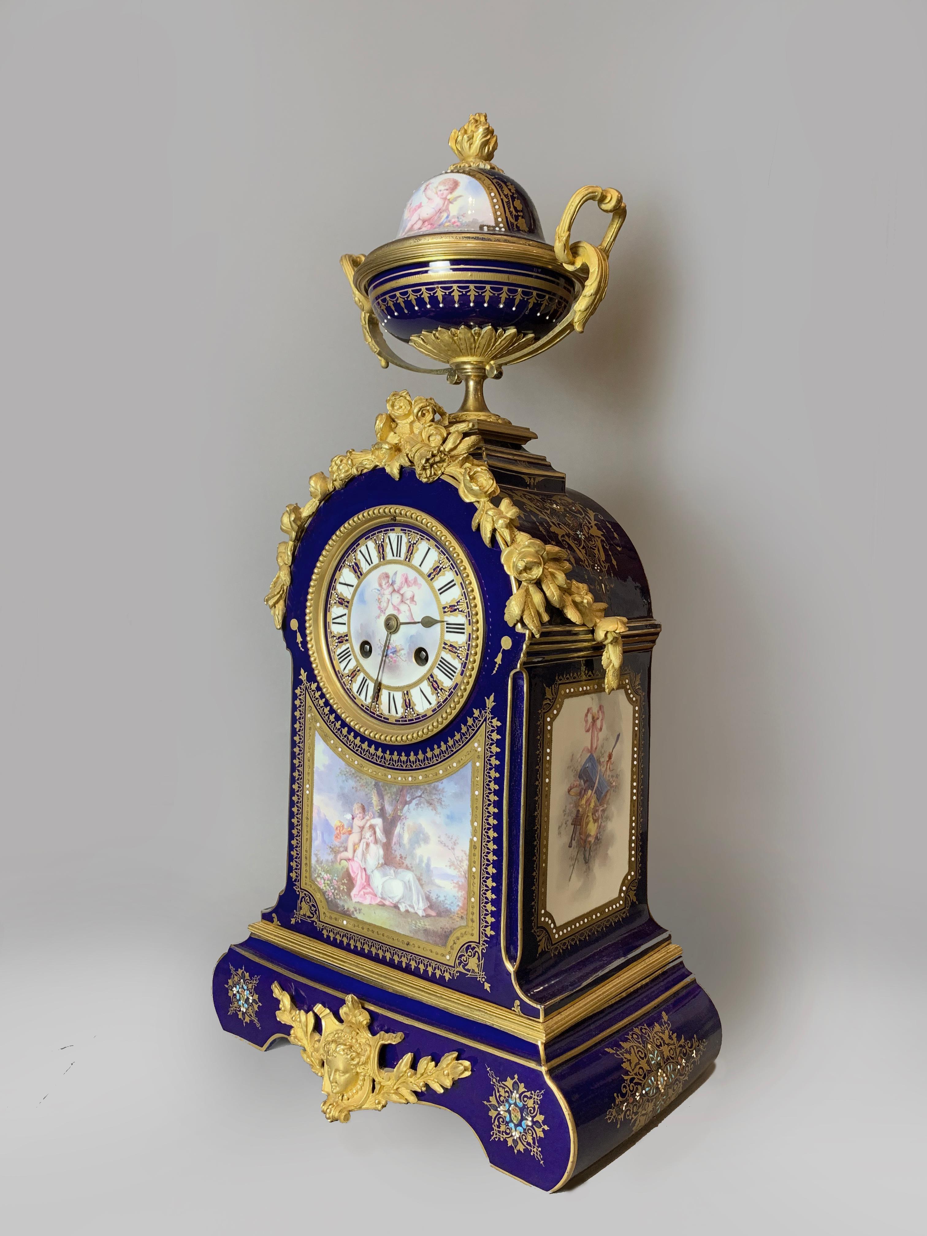 An ornate gilt bronze-mounted Sèvres-style blue ground mantel clock. 

French, circa 1880.

An ornate gilt bronze-mounted Sèvres-style blue ground mantel clock, the shaped rectangular case painted with Venus and Cupid in a 'jewelled' gilt panel