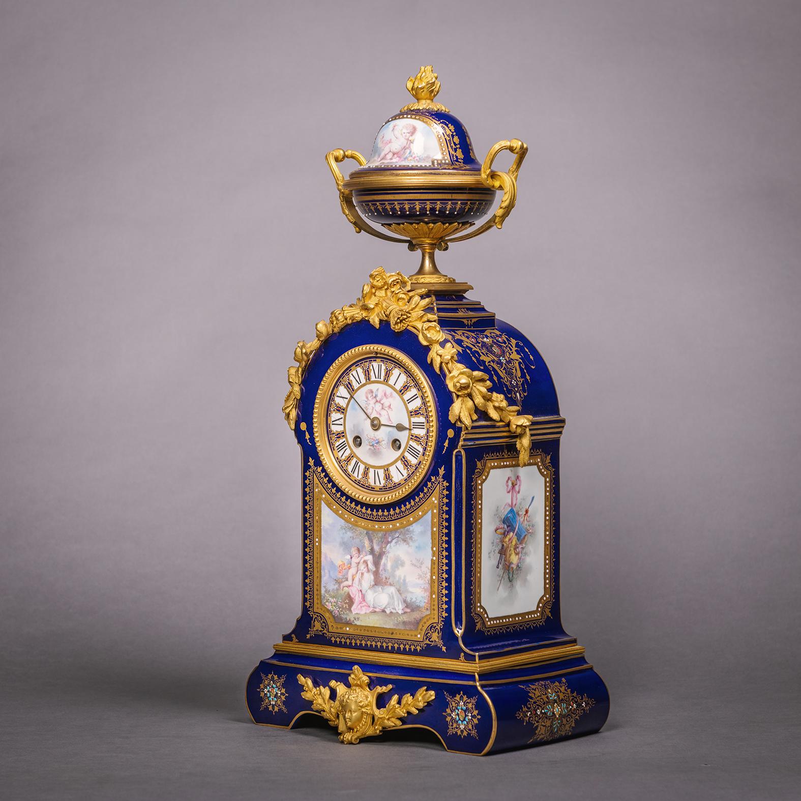 An ornate gilt bronze-mounted Sèvres-style blue ground mantel clock. 

French, circa 1880.

An ornate gilt bronze-mounted Sèvres-style blue ground mantel clock, the shaped rectangular case painted with Venus and Cupid in a 'jewelled' gilt panel