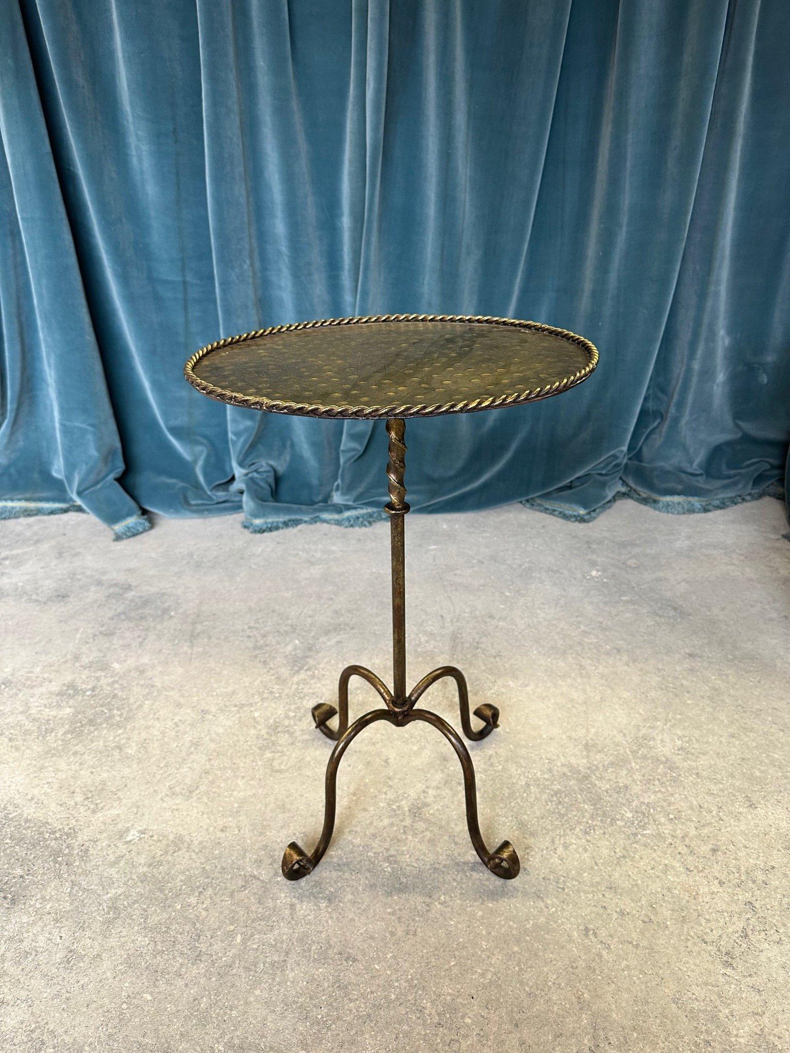 This ornate and unusual Spanish gilt metal side or drinks table was recently handcrafted by skilled artisans using conventional iron-working techniques with an emphasis on superior quality. Each curve and detail on the table signifies the touch of a