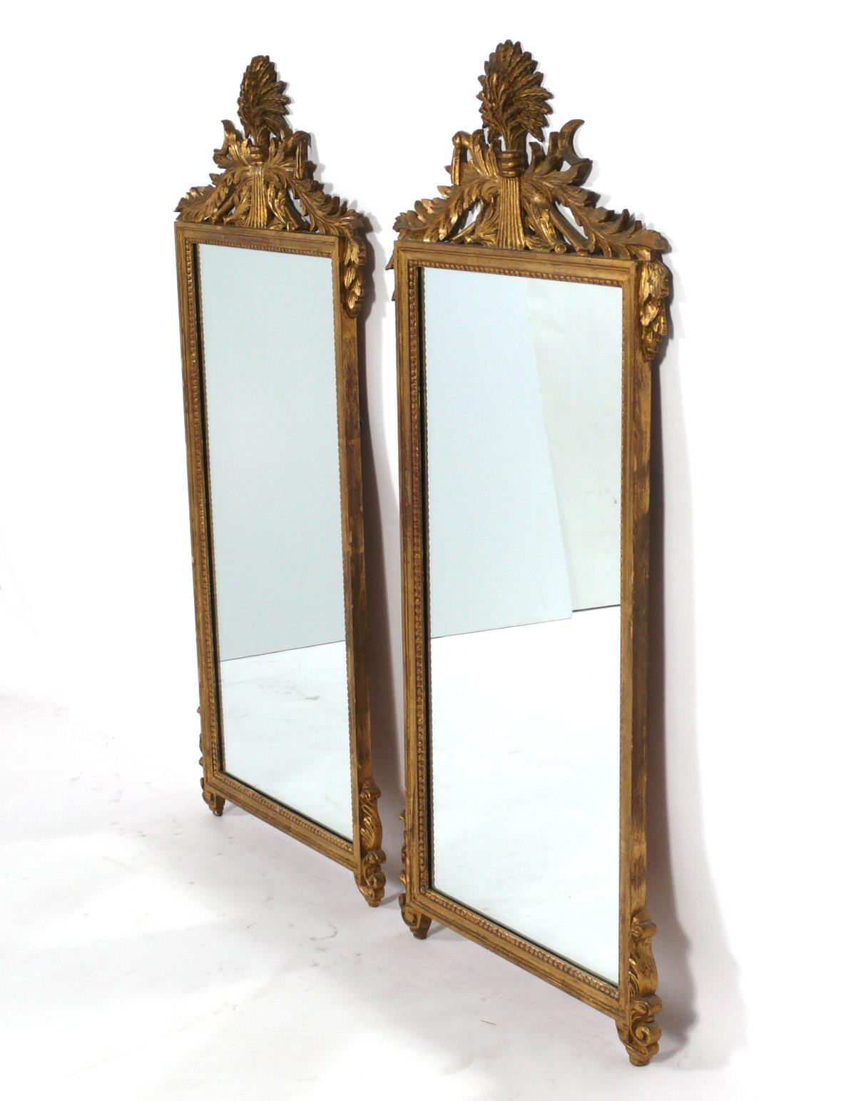 Ornate gilt mirrors, American, circa 1950s. These mirrors were recently removed from the legendary Carlyle Hotel in NYC. We have a pair of these mirrors available. They are priced at $2,250 each. 