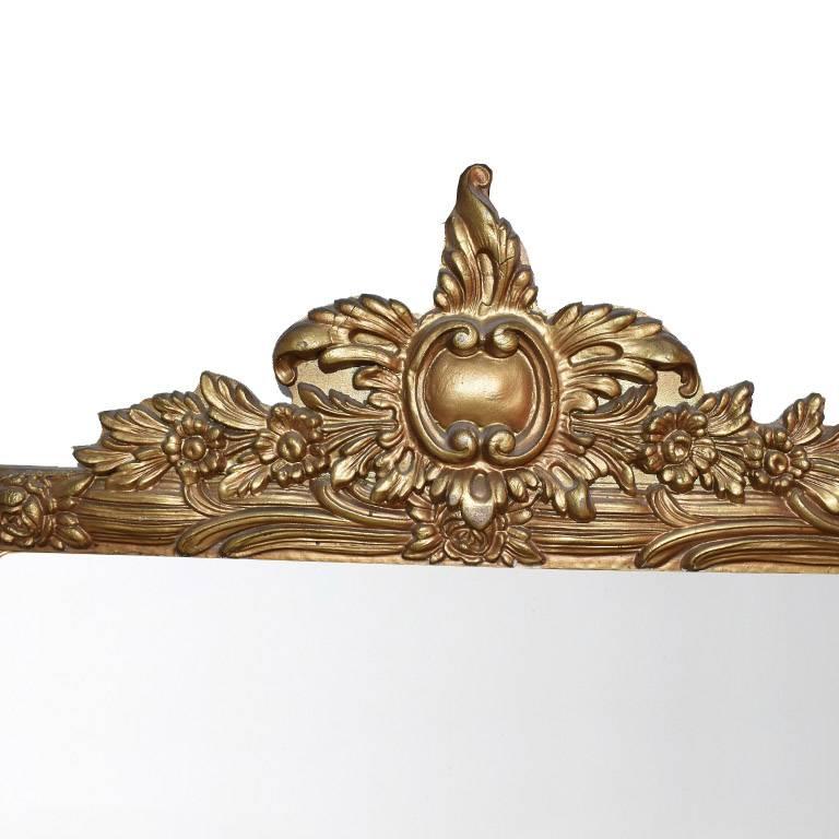 Large horizontal rectangular profile giltwood mirror. In a wide rectangular shape, with hand-carved details on top. Wear is consistent with age. Gorgeous over a mantel, or as an addition to a wall of mirrors. Back includes a wire for hanging.
