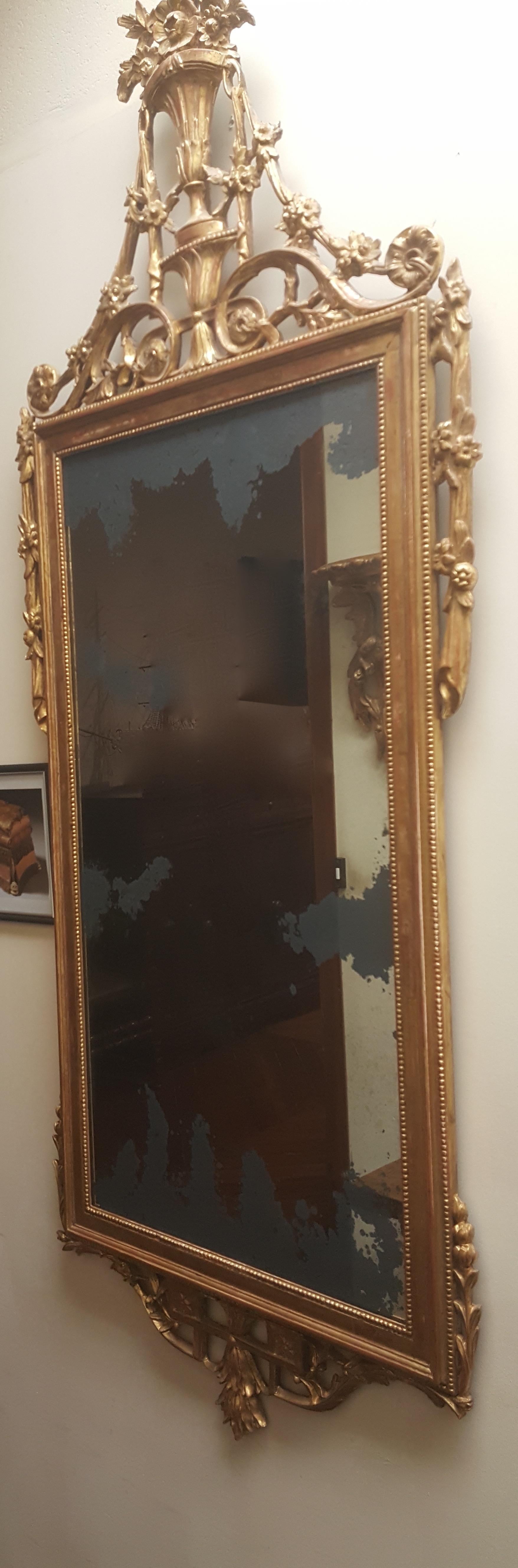 Ornate delicate hand carved giltwood mirror, heavily aged silvering in mirror.