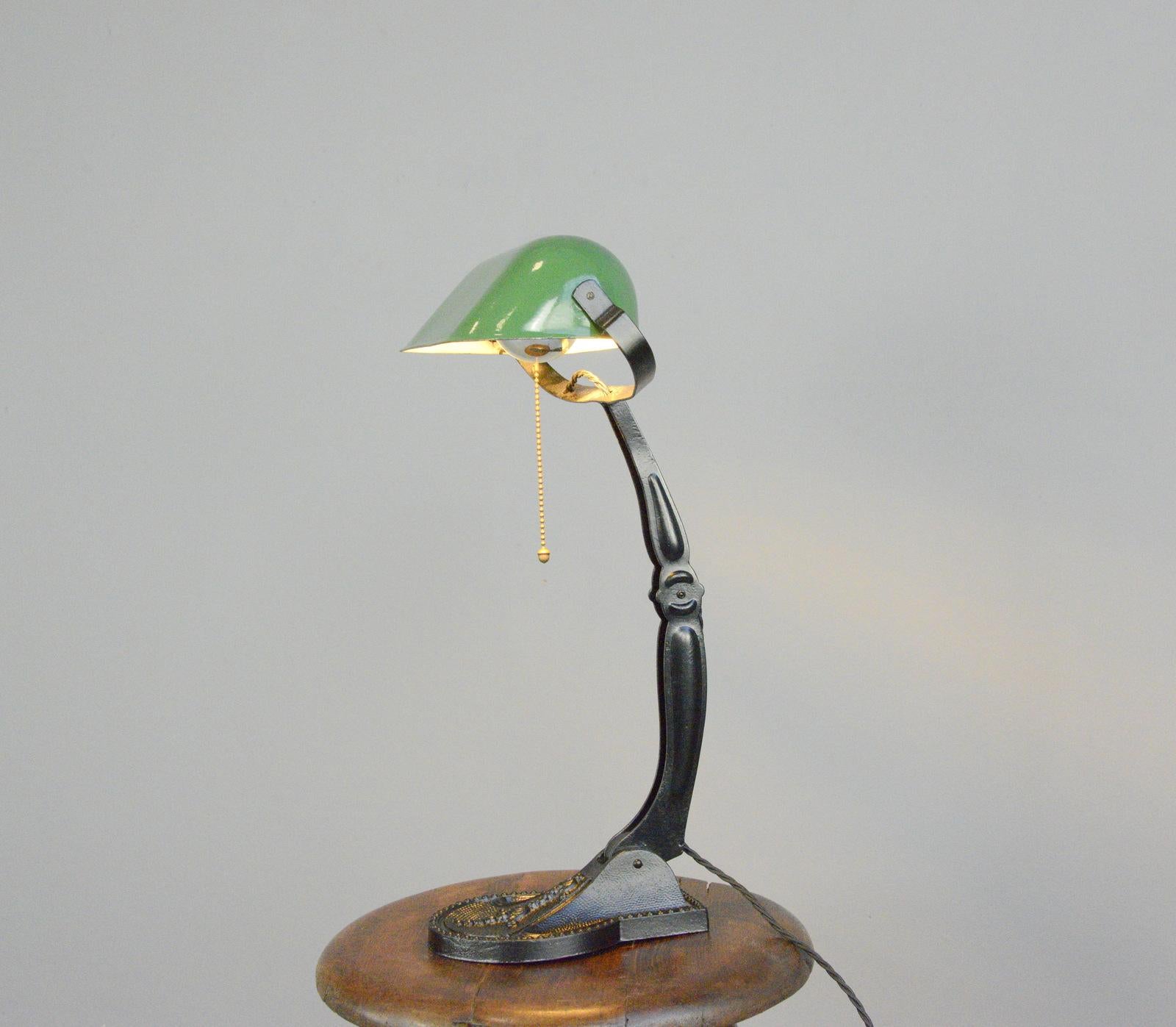 Ornate Hungarian bankers desk lamp, circa 1920s.

- Cast Iron base
- Vitreous green enamel shade
- Shade and arm are adjustable
- Takes E27 fitting bulbs
- On/Off switch on the bulb holder
- Hungarian, circa 1920s
- Measures: 46cm tall x