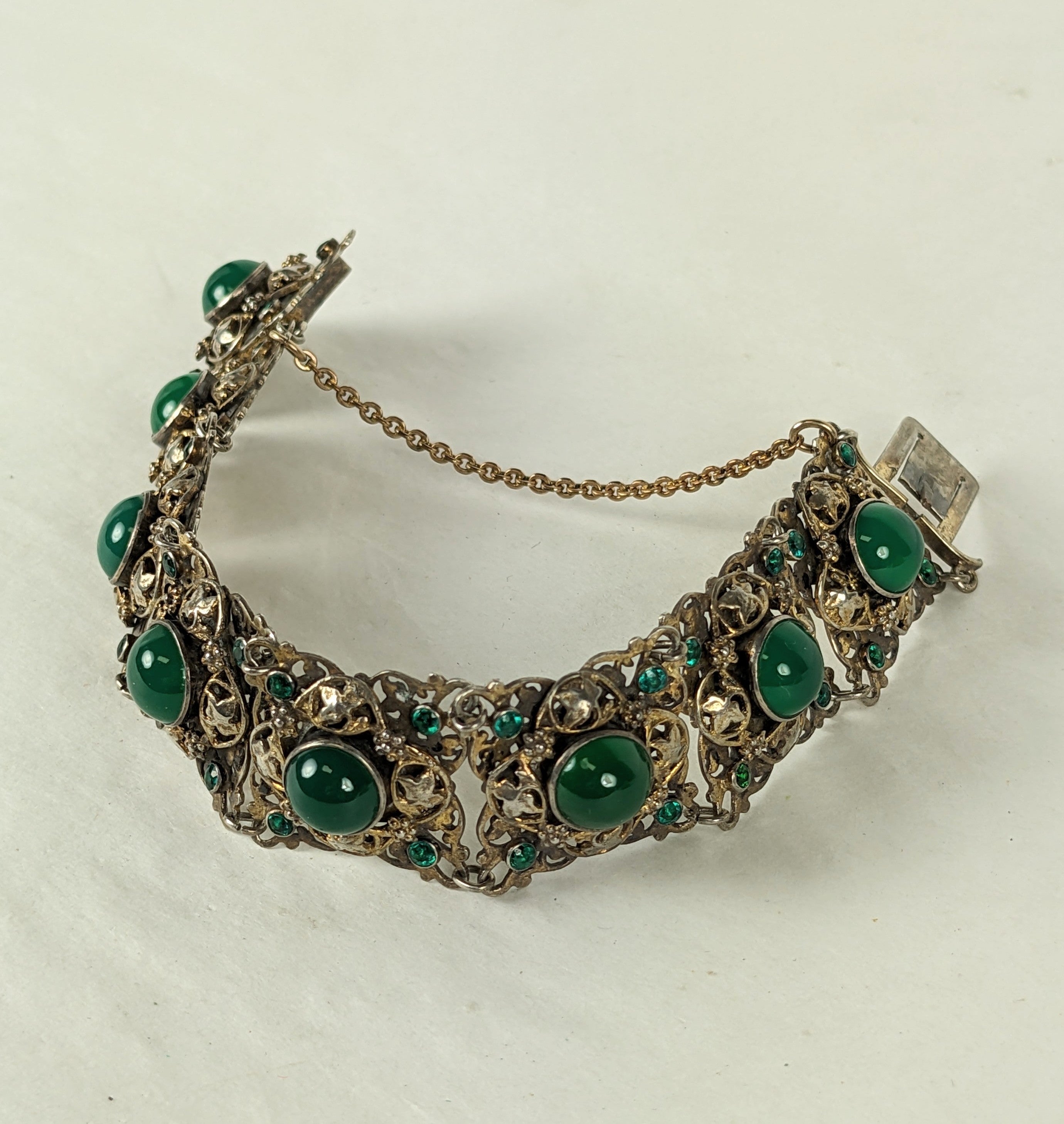 Lovely Hungarian Green Onyx Bracelet with emerald paste accents. Ornate metal work with floral and leaf motifs in silver with vermeil accents. 
1920's Hungarian. 7.25