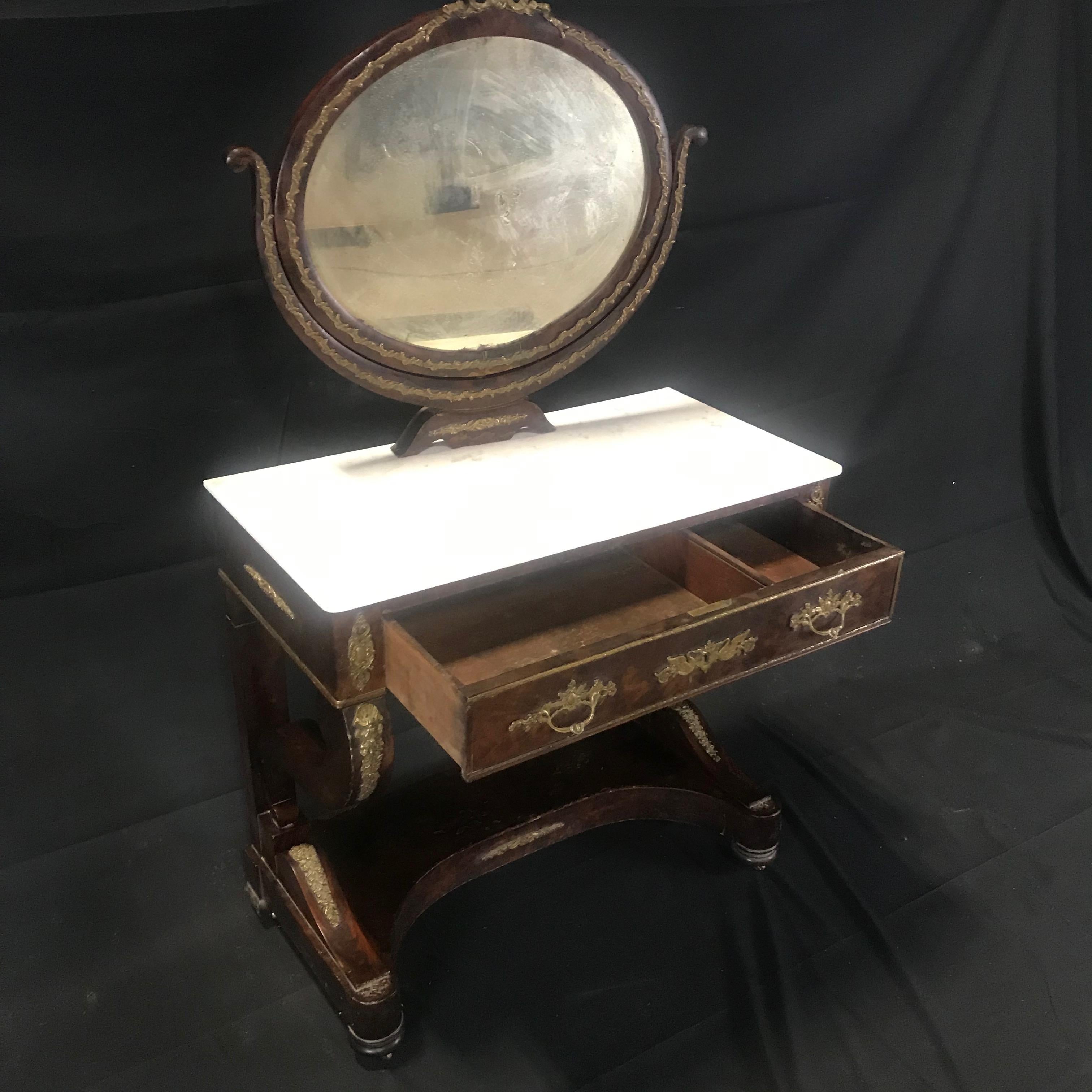 A French Charles X Empire period mahogany dressing table with original marble top and gorgeous bronze decoration. Some losses to the veneer (see photos). All original.
#5707
Measures: H skirt 24.25