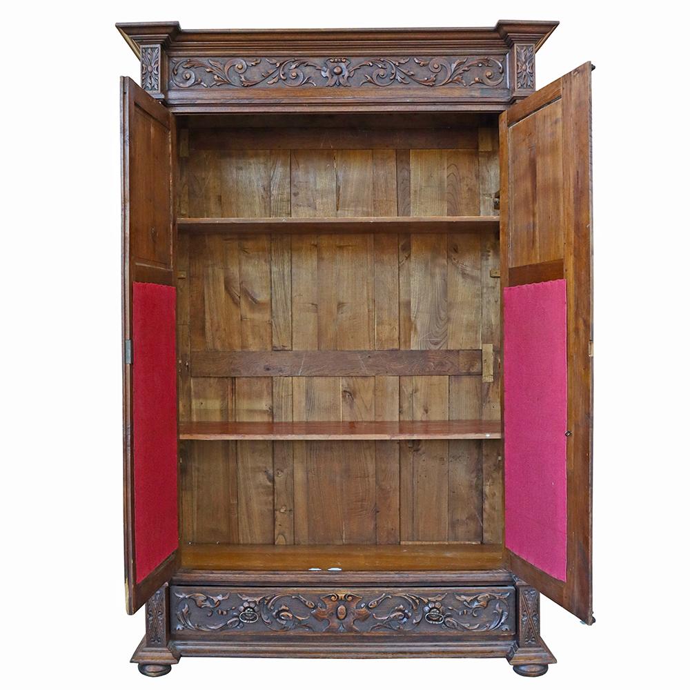 Replete with ornately carved details, this Renaissance Revival bureau is a statement piece. This continental walnut armoire hails from the low countries and has a 19th-century vintage. The cabinet features a wealth of storage hidden by openwork