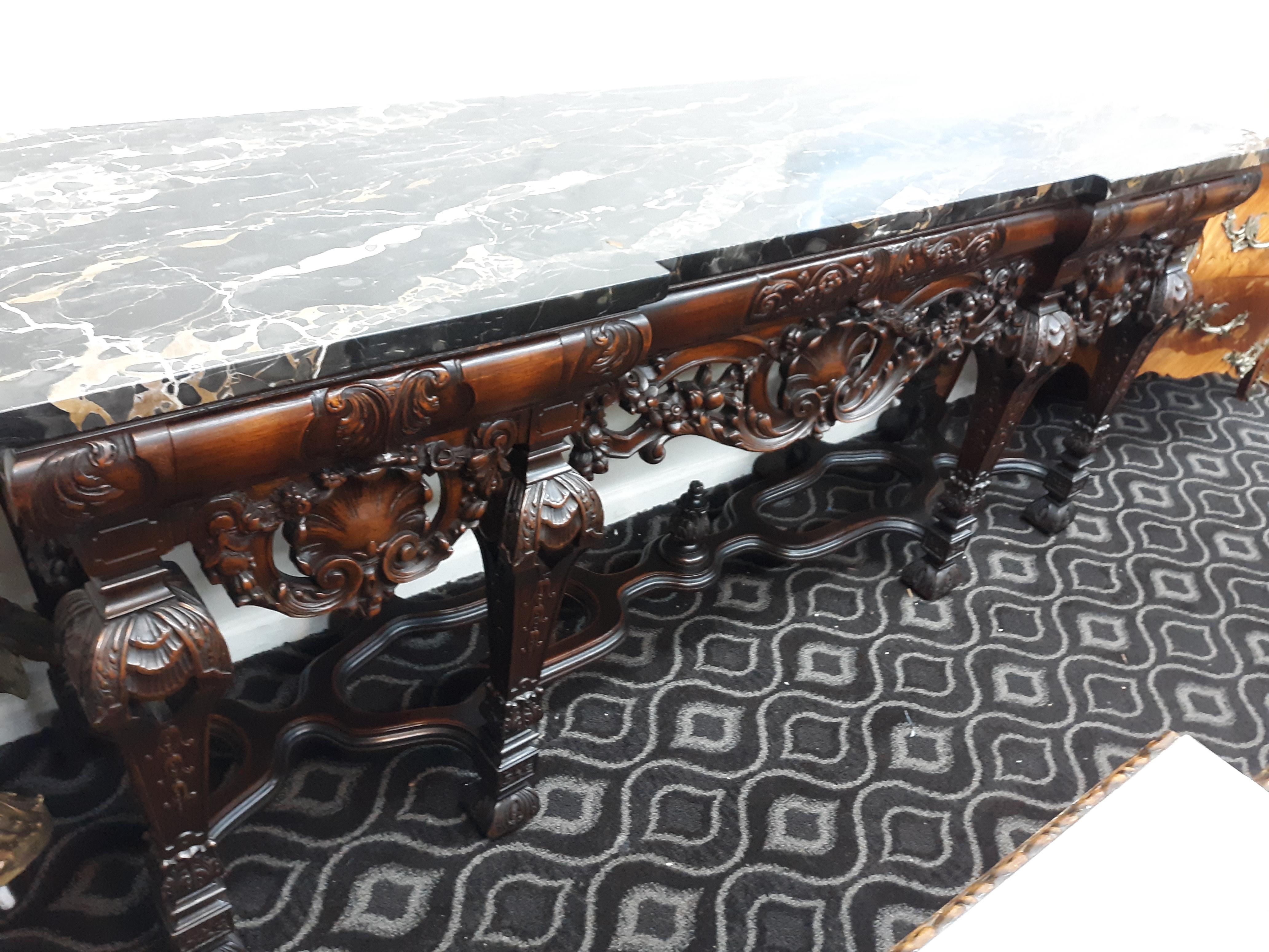 Ornate Mahogany entrance table circa 1920 with black marble top. This rare piece makes the house. Period. A gorgeous crafted piece of work, solid and heavy, of which the seller only knows of 3 in existence (One of the other 2 is privately owned, and