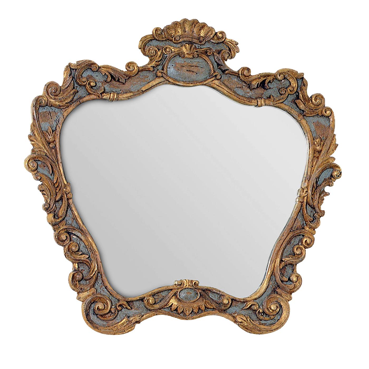 An ode to 18th century furniture, this mirror is an exquisite example of masterful craftsmanship. The frame is in solid wood that was carved by hand and finished with an antique-like treatment and a combination of a traditional grey-blue color