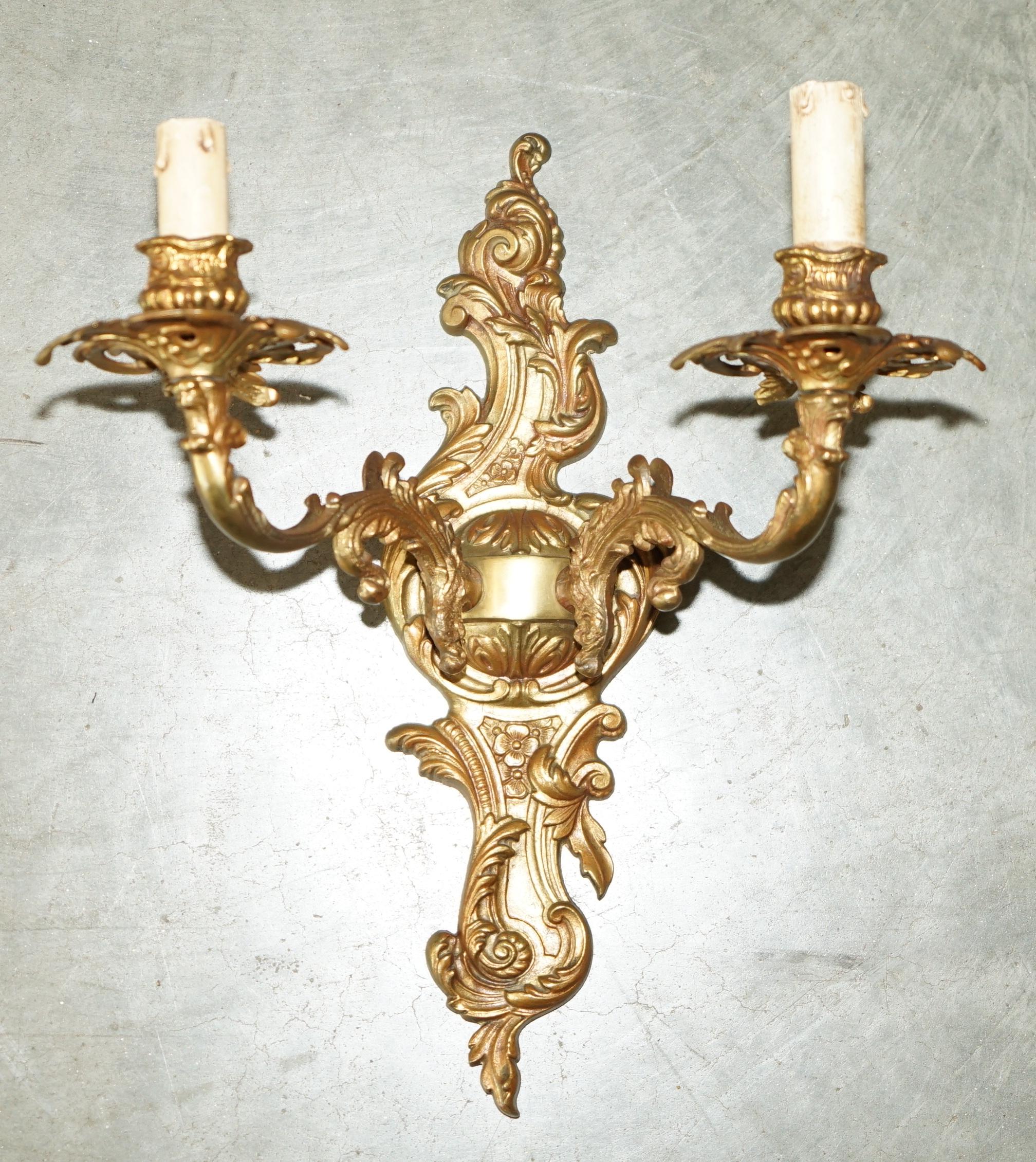Royal House Antiques

Royal House Antiques is delighted to offer for sale this exquisite pair of very ornate Rococo style circa 1920-1940'S gilt bronzed French wall sconce Candle lamps 

These came from my favorite antiques dealer in Belgium along